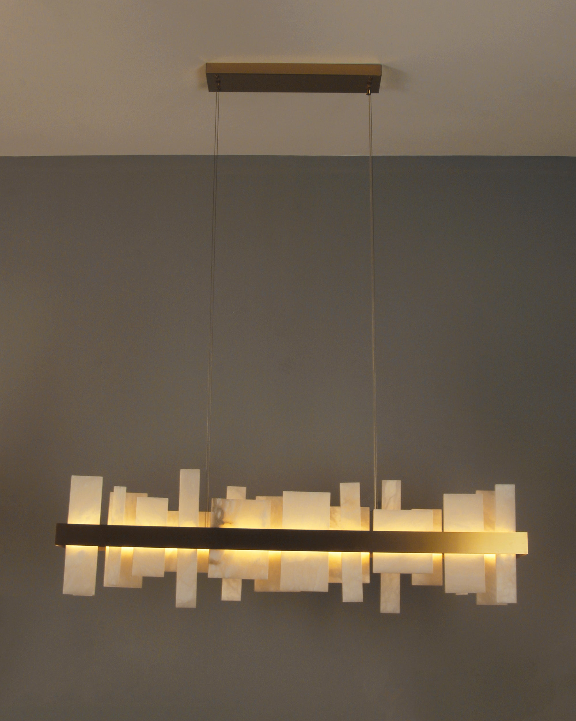 Close up of natural marble panels on VORELLI® Niva rectangular chandelier highlighting architectural texture
