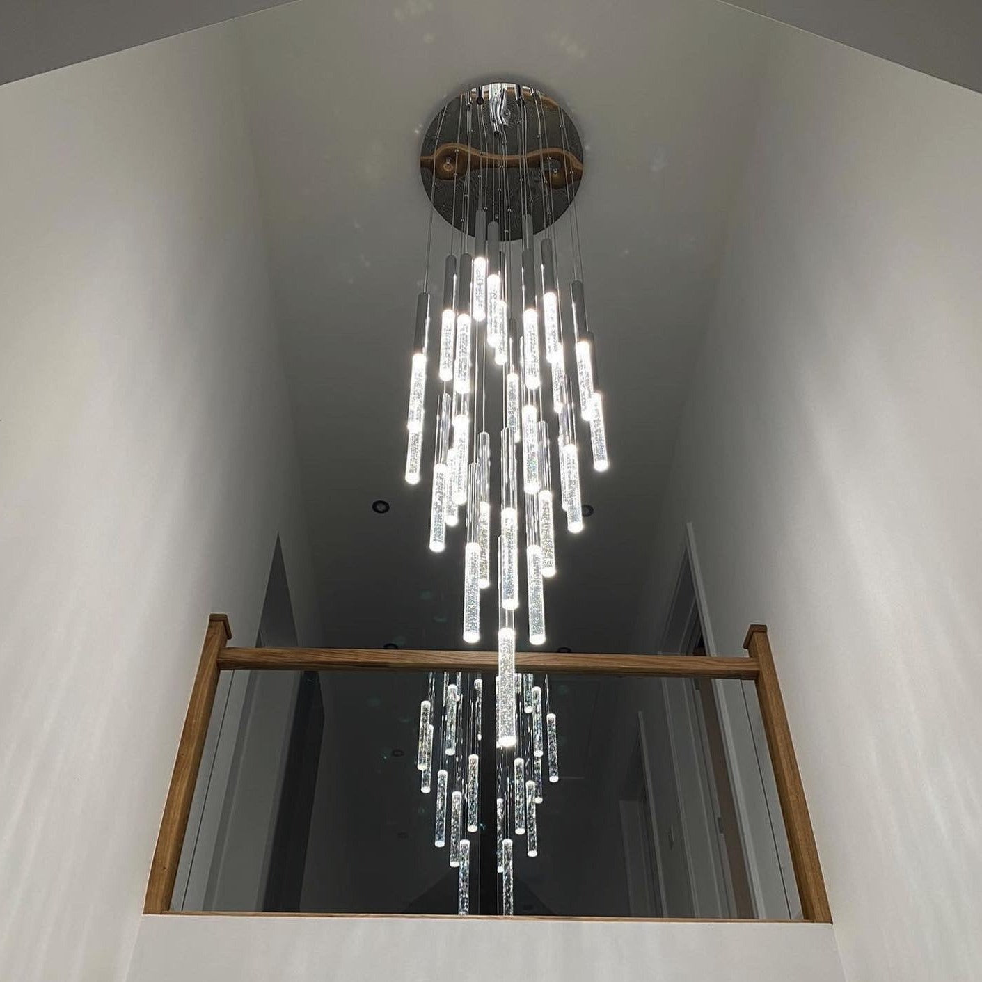 Long cascading crystal chandelier designed for staircases and high ceiling interiors