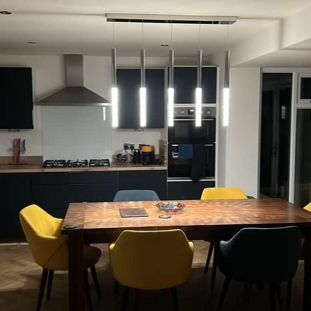 VORELLI® Nyon modern rectangular crystal chandelier installed above dining table with vertical bubble glass pendants