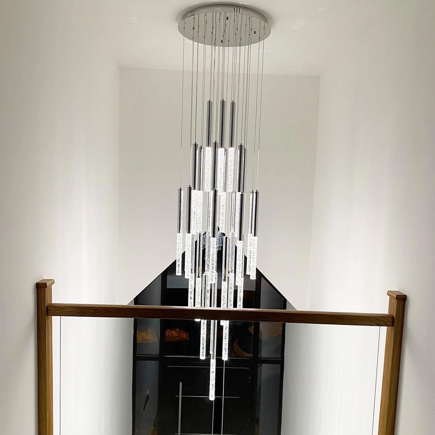 VORELLI® Nyon pendant staircase chandelier with cascading crystal cylinders in a modern stairwell