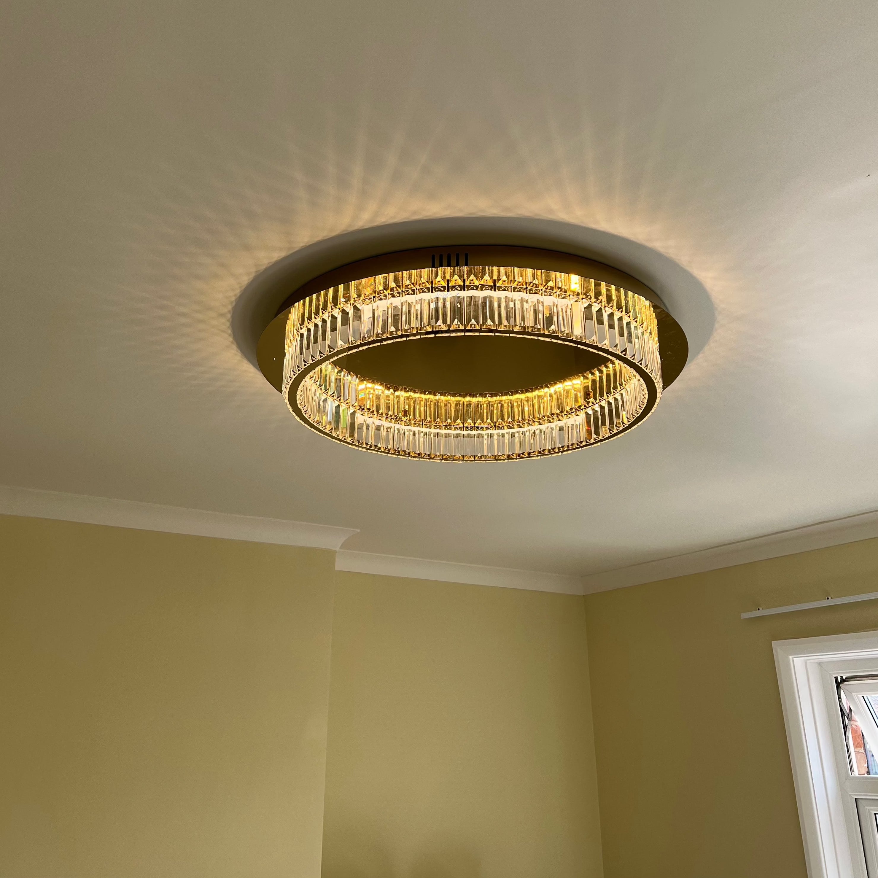 VORELLI® Oia luxury crystal ceiling light mounted in contemporary living space with perimeter crystal detailing