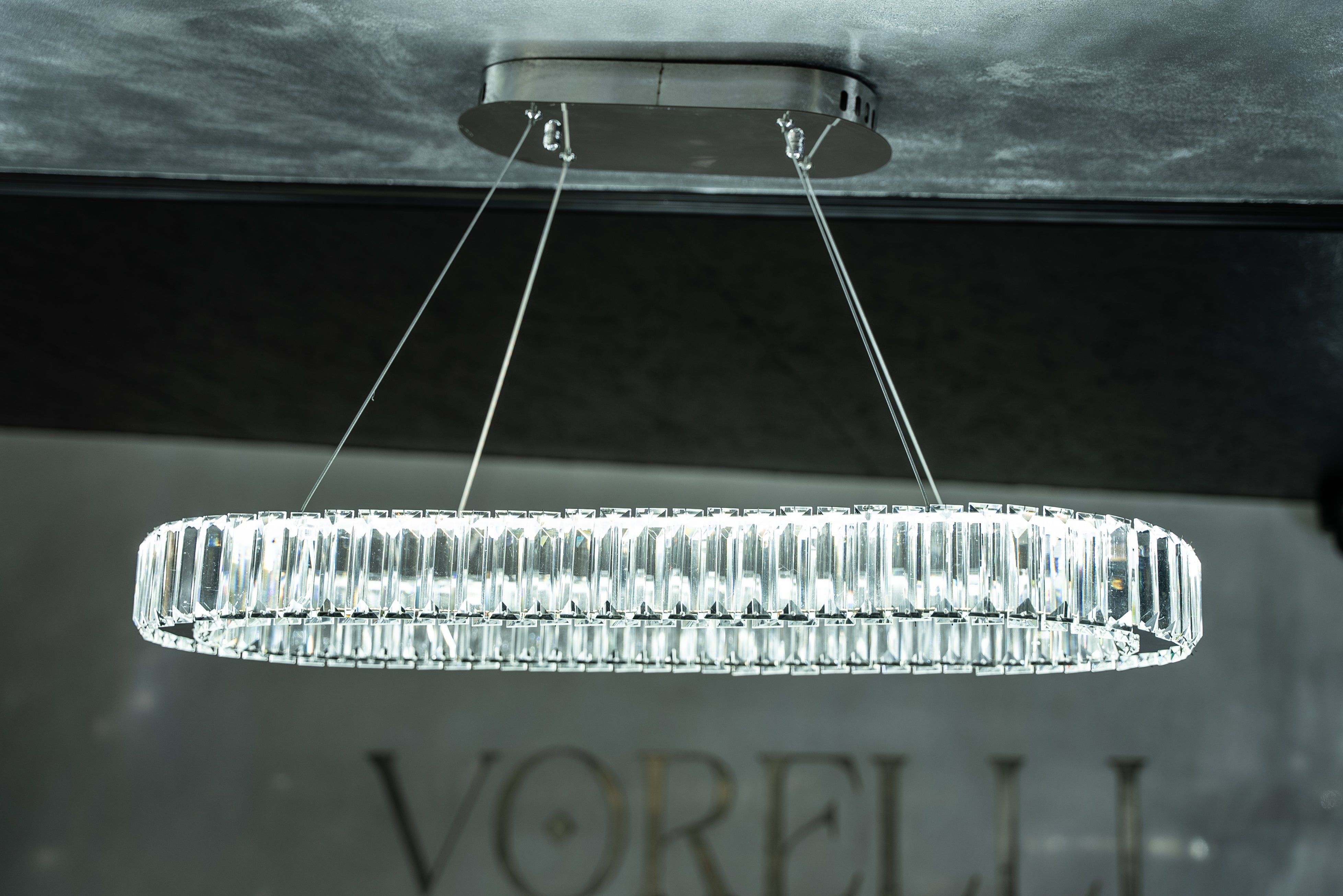 VORELLI® Oia luxury linear crystal chandelier installed in contemporary interior creating refined ambient lighting