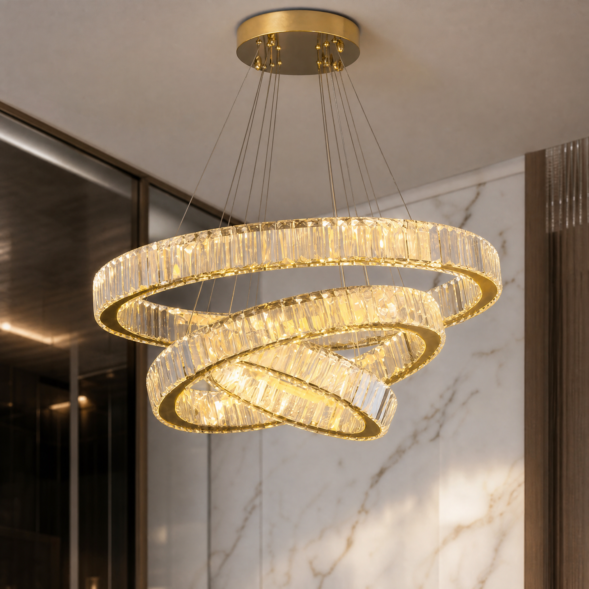 A detailed closeup showcasing the shimmering crystal bars and premium stainless steel finish of the VORELLI Oia Trio Ring Circular Chandelier.