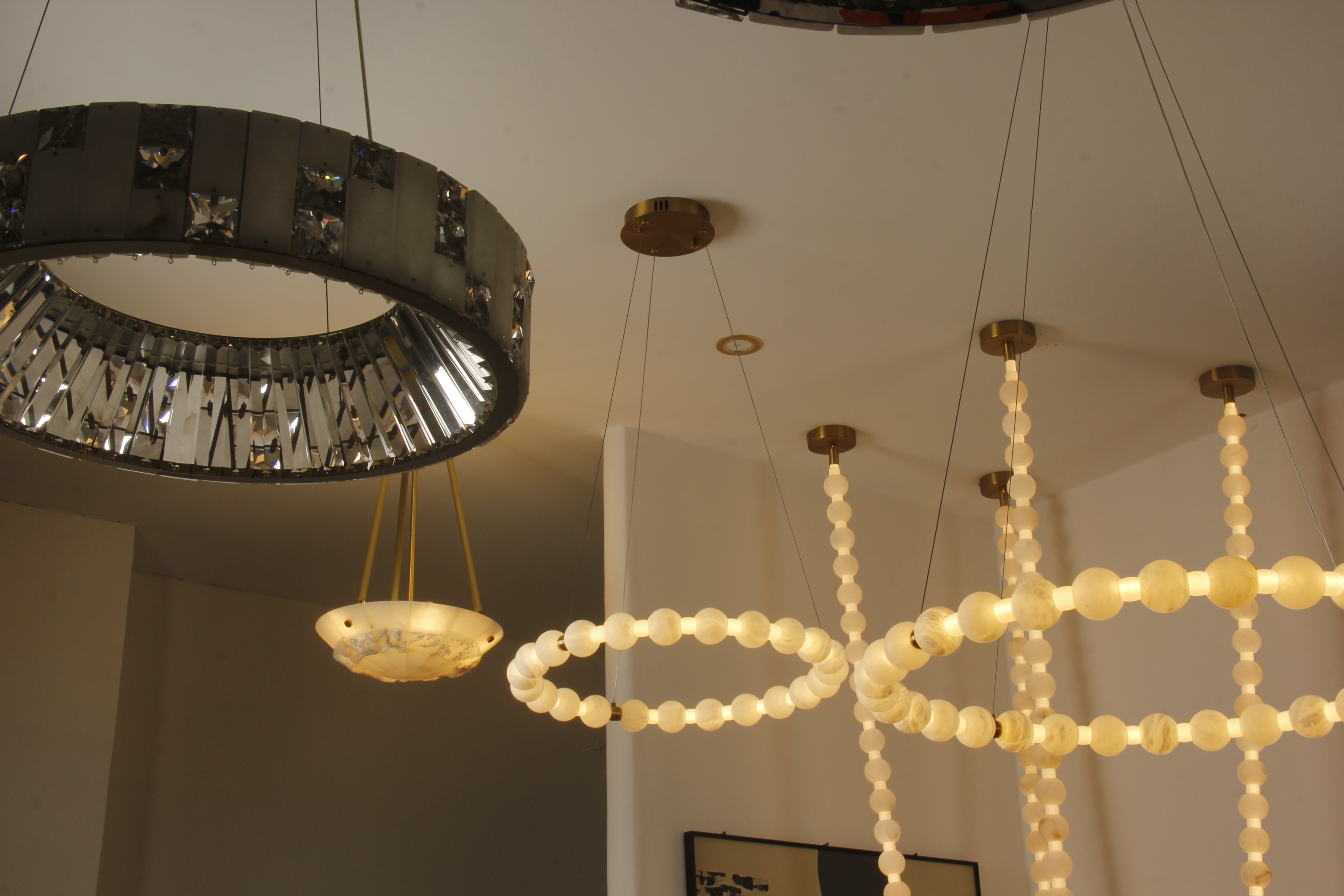 Close up of smooth marble spheres forming illuminated ring on VORELLI® Orbella chandelier