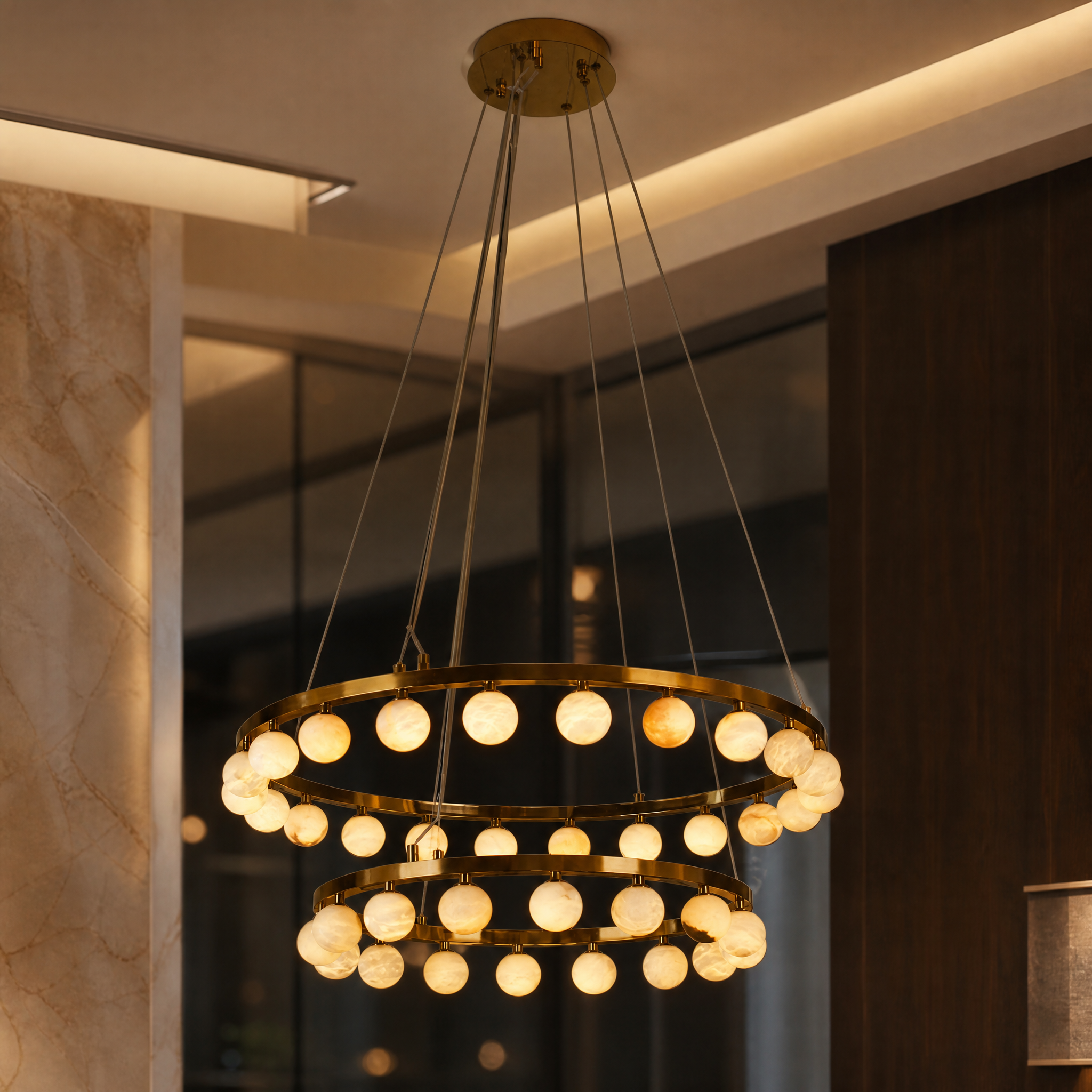 Detailed closeup of the VORELLI Orbit Chandelier showcasing illuminated natural white marble spheres suspended from a minimalist gold circular frame.