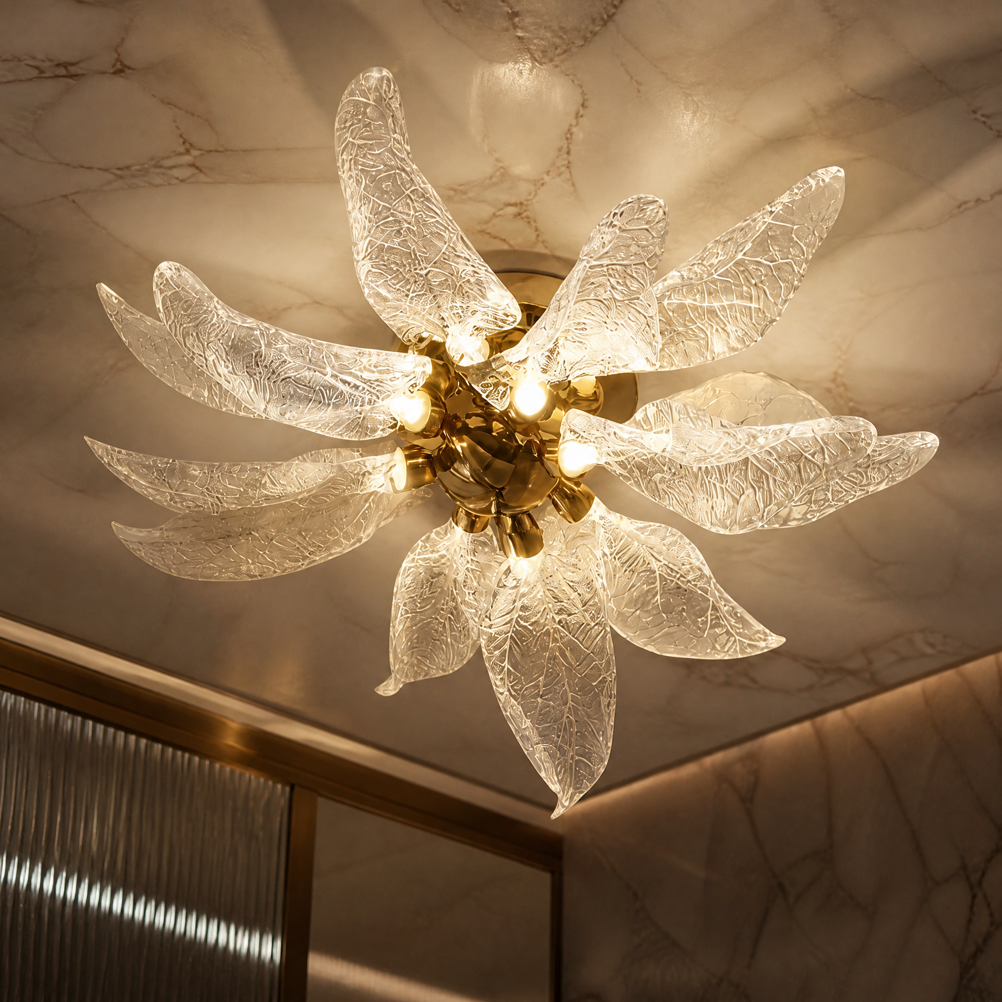 Macro closeup of the delicate, textured amber glass leaves on the VORELLI Ottobre ceiling light, showcasing its nature-inspired design.