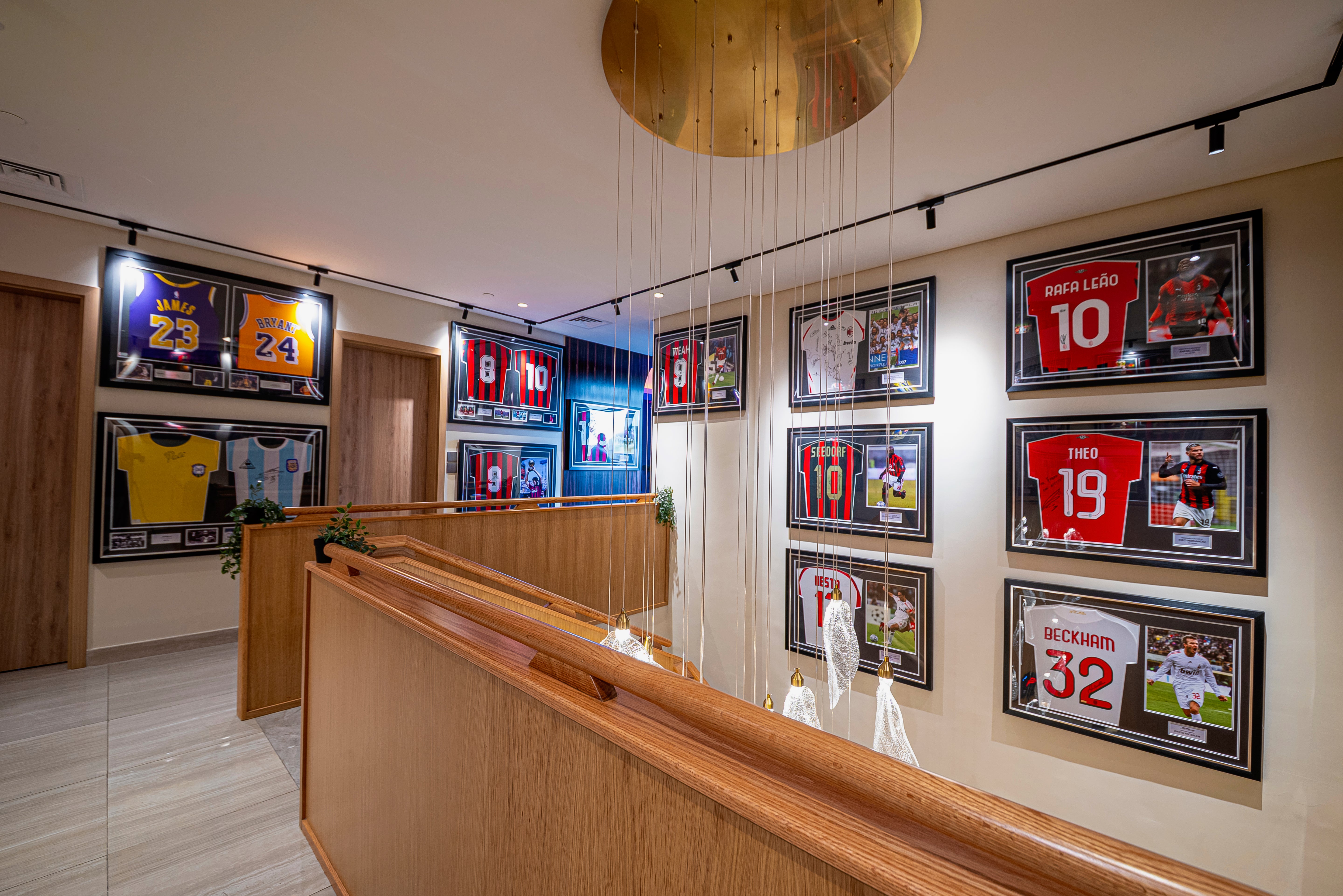 VORELLI® Ottobre modern staircase chandelier cascading above a designer stairwell with framed artwork and architectural lighting