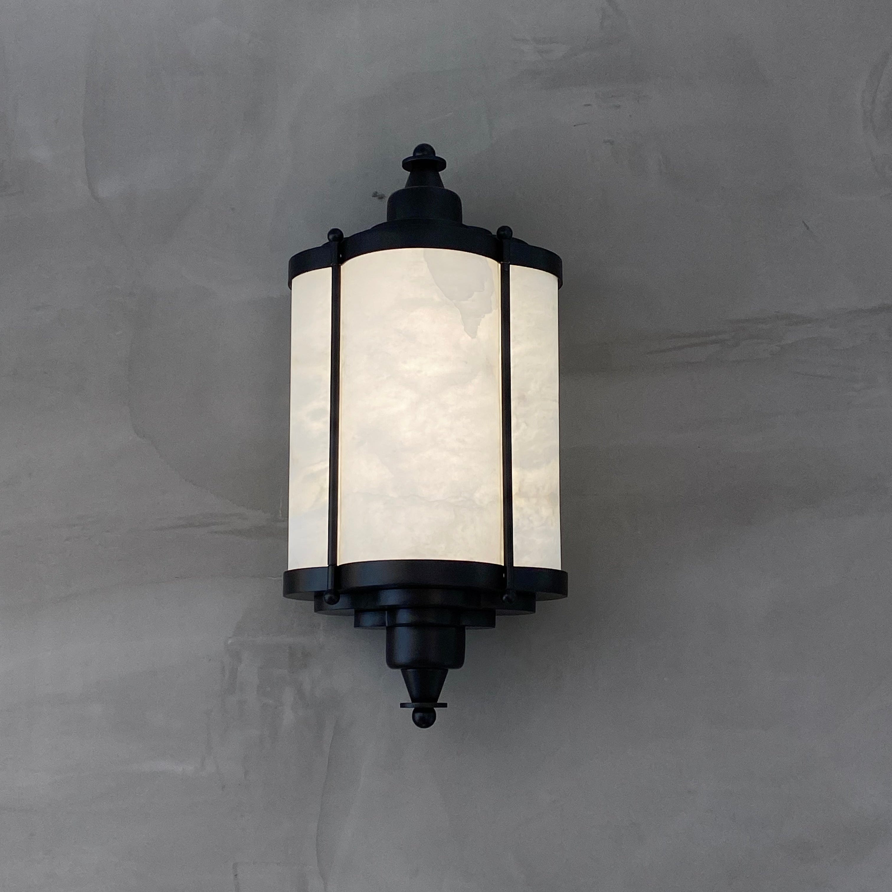 VORELLI® Palmar modern marble wall sconce highlighting architectural lantern silhouette and natural stone panels