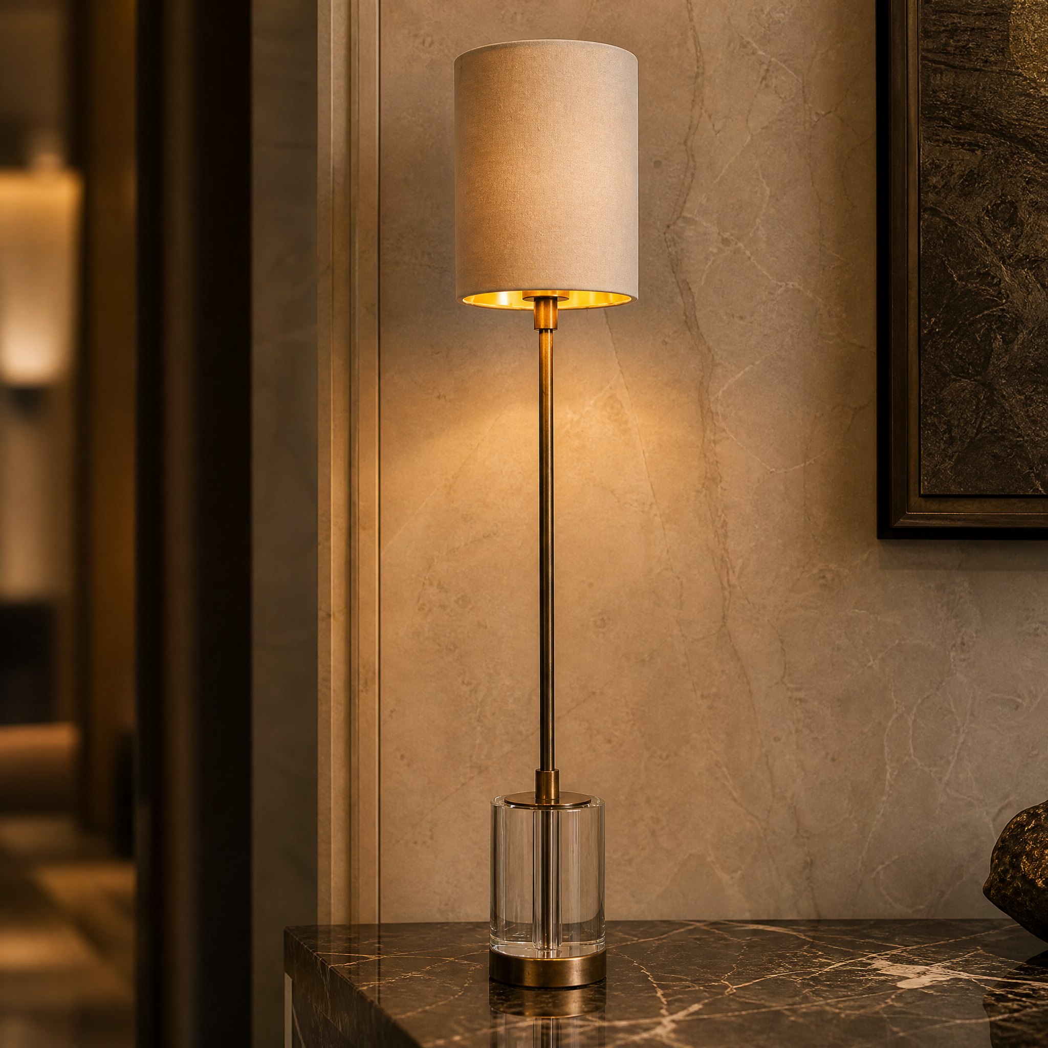 Macro closeup of the VORELLI Renvaro table lamp showcasing the slender antique brass stem and the premium clear crystal base.