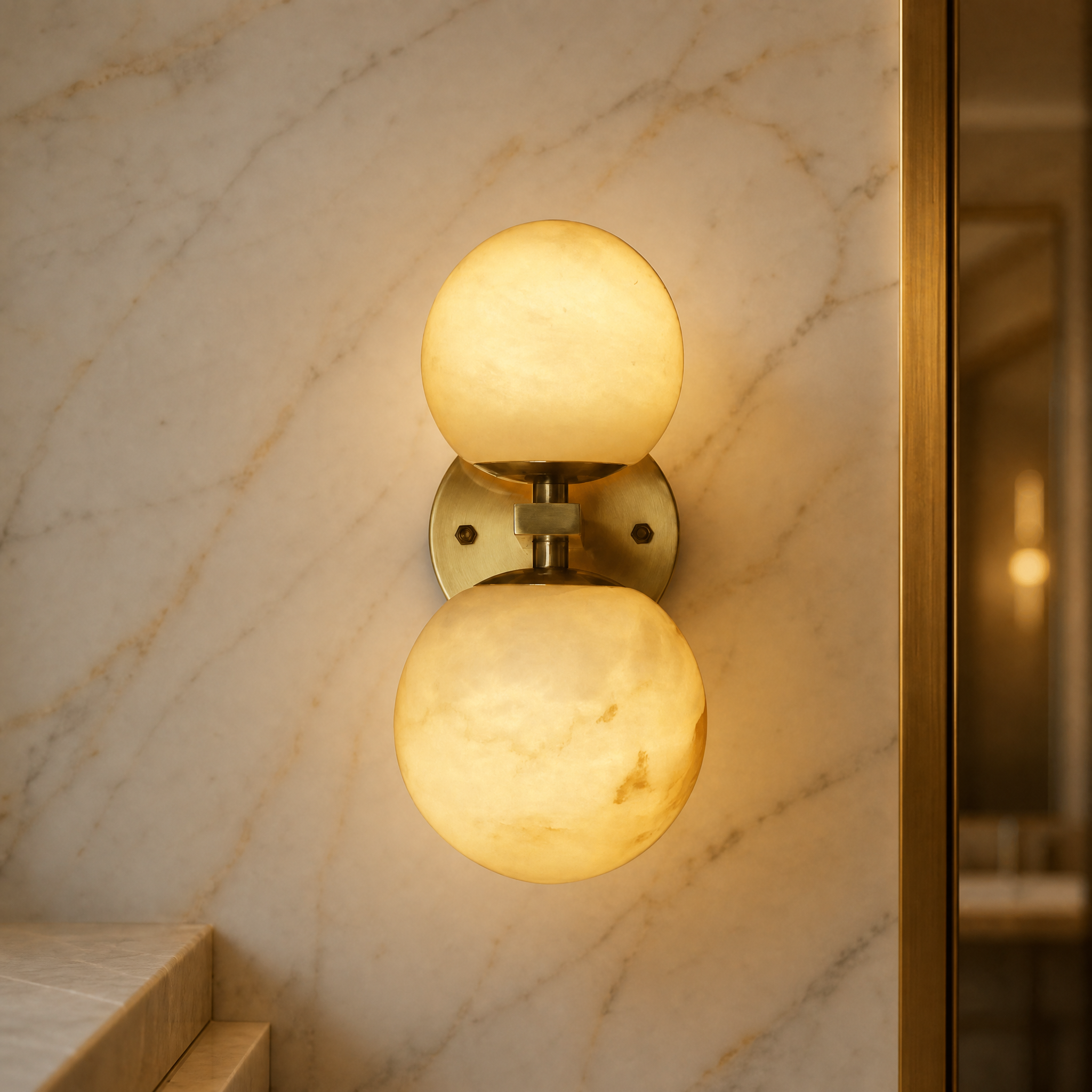 Macro shot of the VORELLI Ricco Wall Light, emphasizing the smooth texture of the sculpted marble globes and sleek brass hardware.