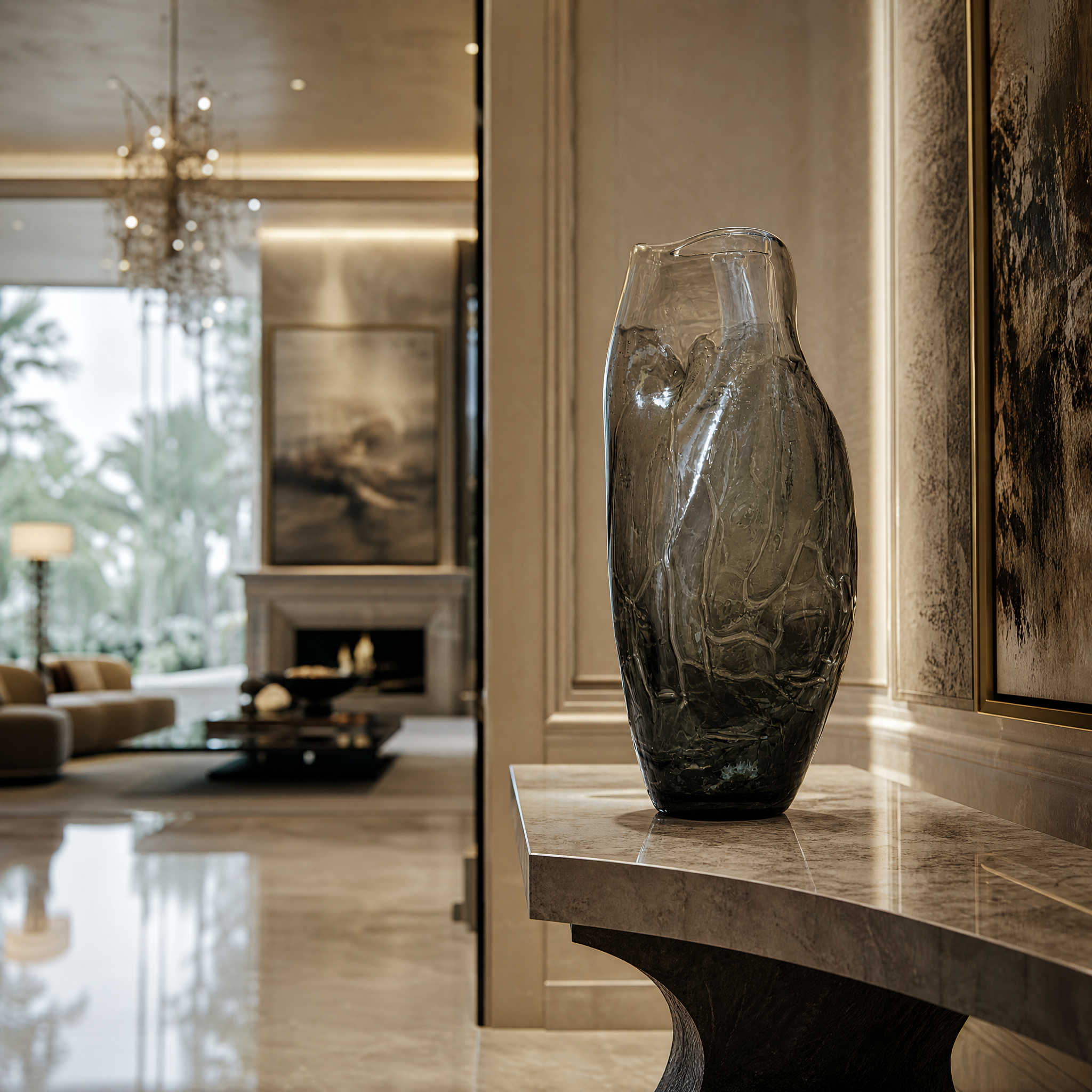 The VORELLI Rivano glass vase, featuring an organic elongated shape and grey-to-clear gradient, styled as a sophisticated decor piece in a modern residential living room setting.