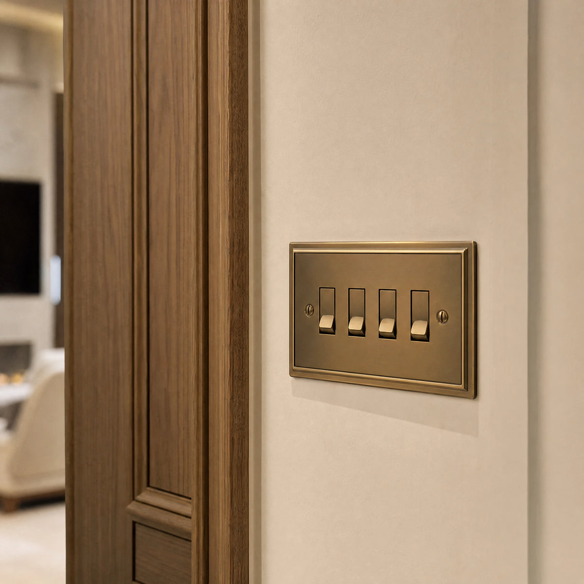 Close-up of a luxury antique brass rocker switch installed within feature wall beside an elegant doorway with refined timber panelling by VORELLI®.