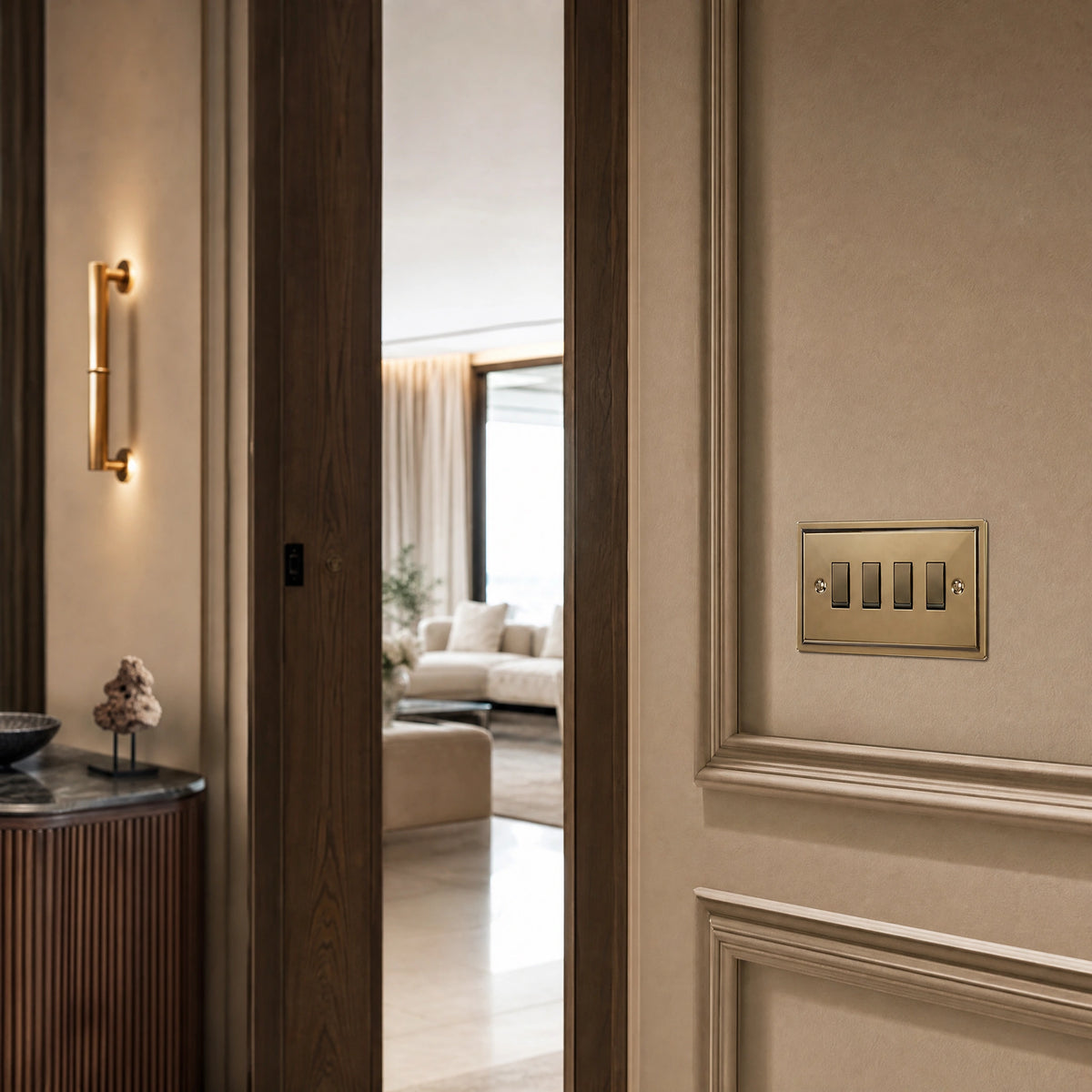 Luxury antique brass rocker switch installed within feature wall beside an elegant doorway with refined timber panelling in a UHNW interior by VORELLI®.