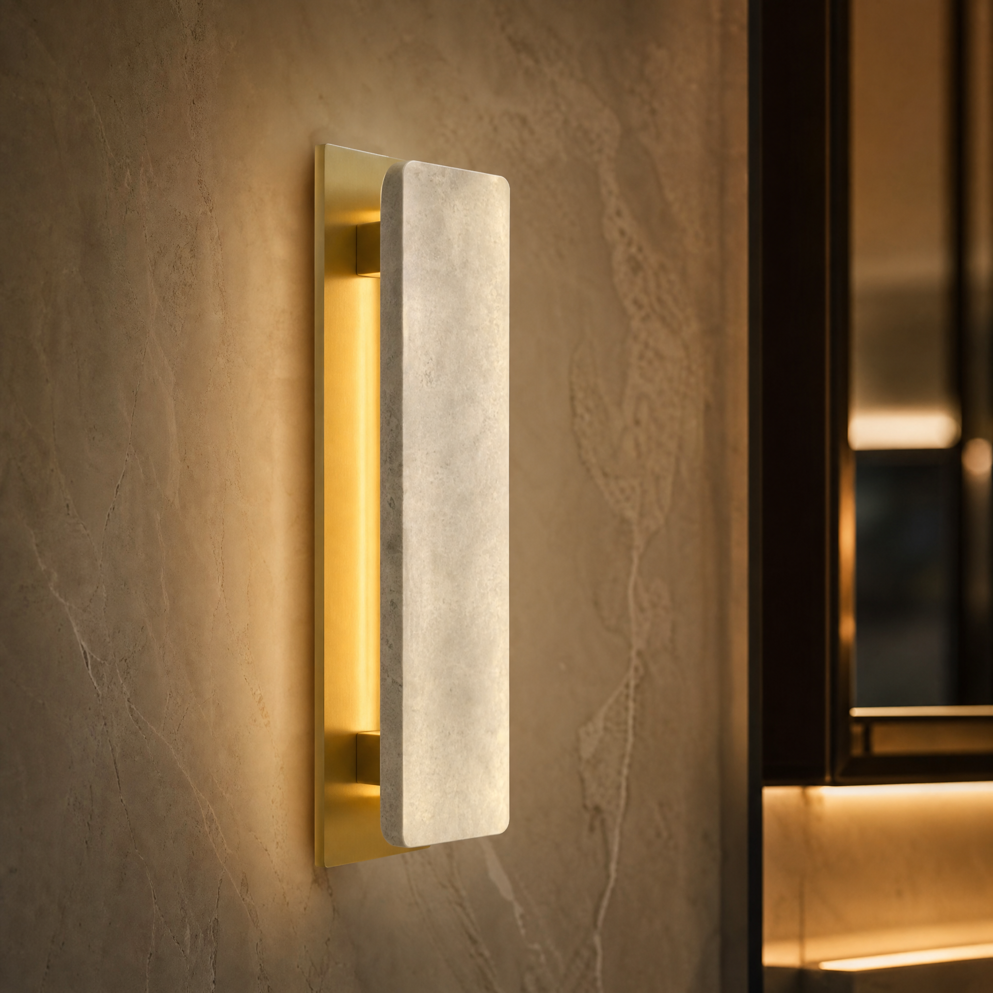 Macro closeup of the VORELLI Salerno wall light highlighting the smooth, honed texture of the natural marble surface bordered by a refined, warm golden metal base.