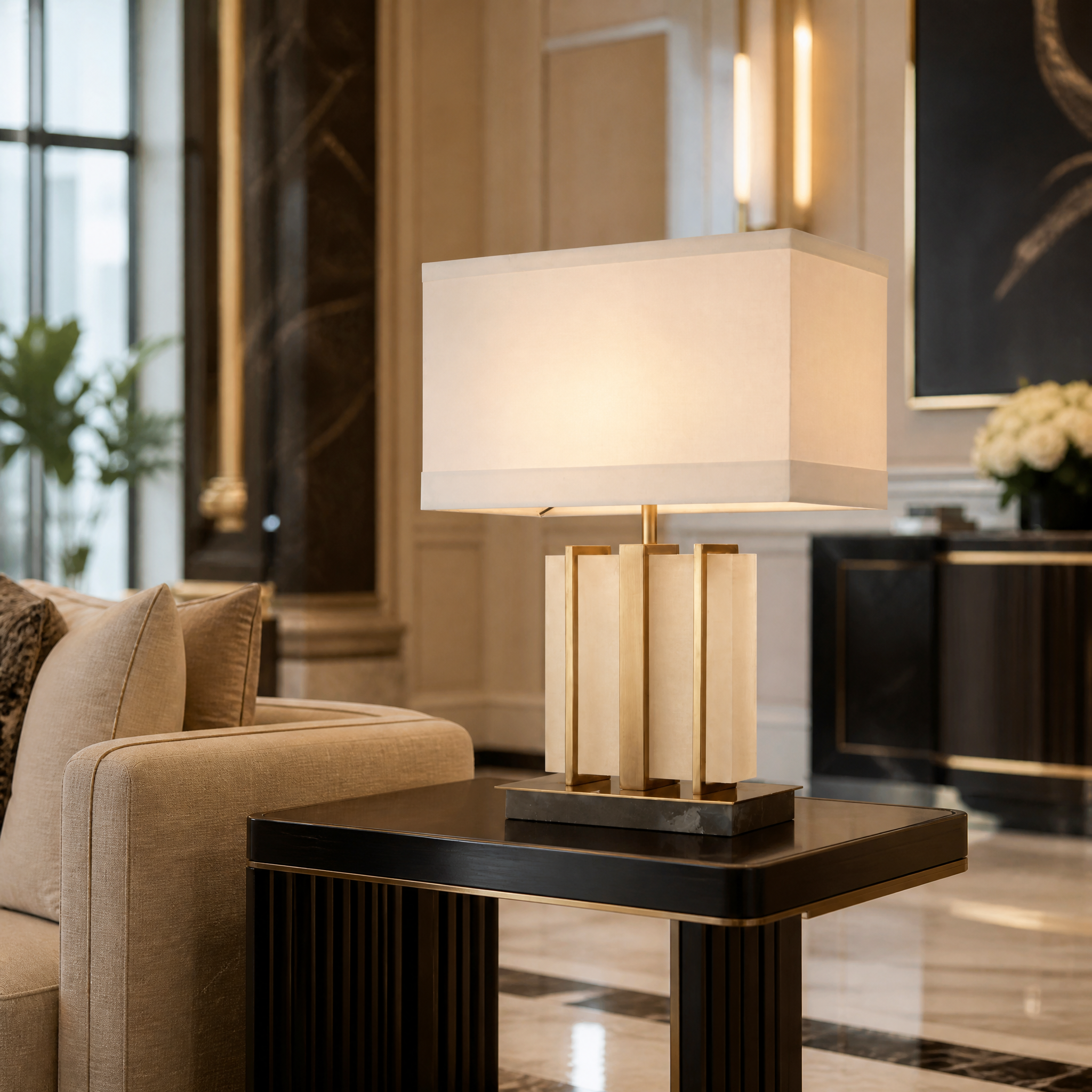 An elegant Seravia Alabaster Brass Table Lamp adding architectural elegance and structured geometric design to a high-end hotel lounge or reception desk.