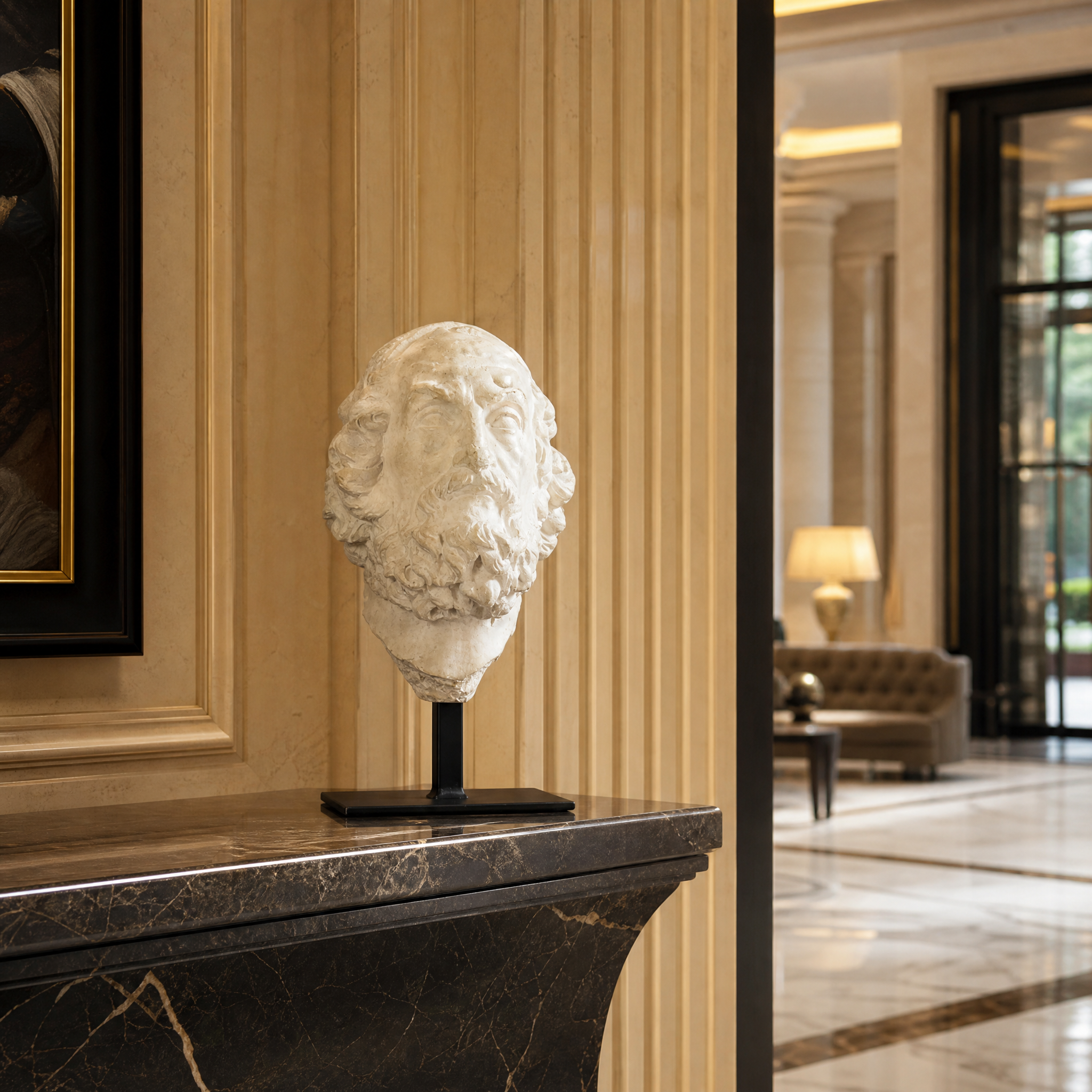 The VORELLI Spirano decorative male bust on a black metal stand featured as a sophisticated accent piece on a luxury hotel lobby reception sideboard.