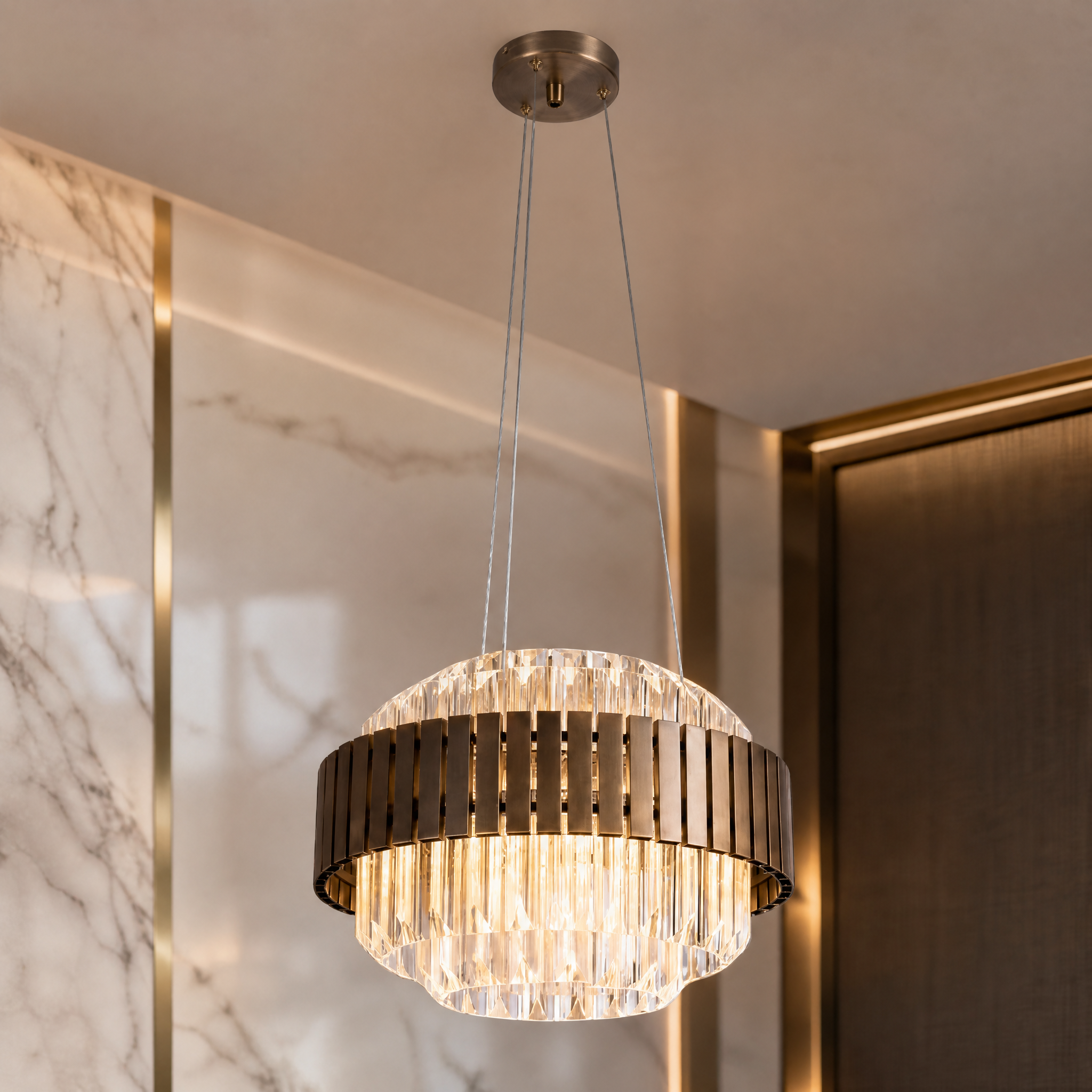A macro close-up view of the VORELLI Taviano circular chandelier, highlighting the rich texture of the vertical outer panels and the cascade of diamond-cut faceted crystal prisms.