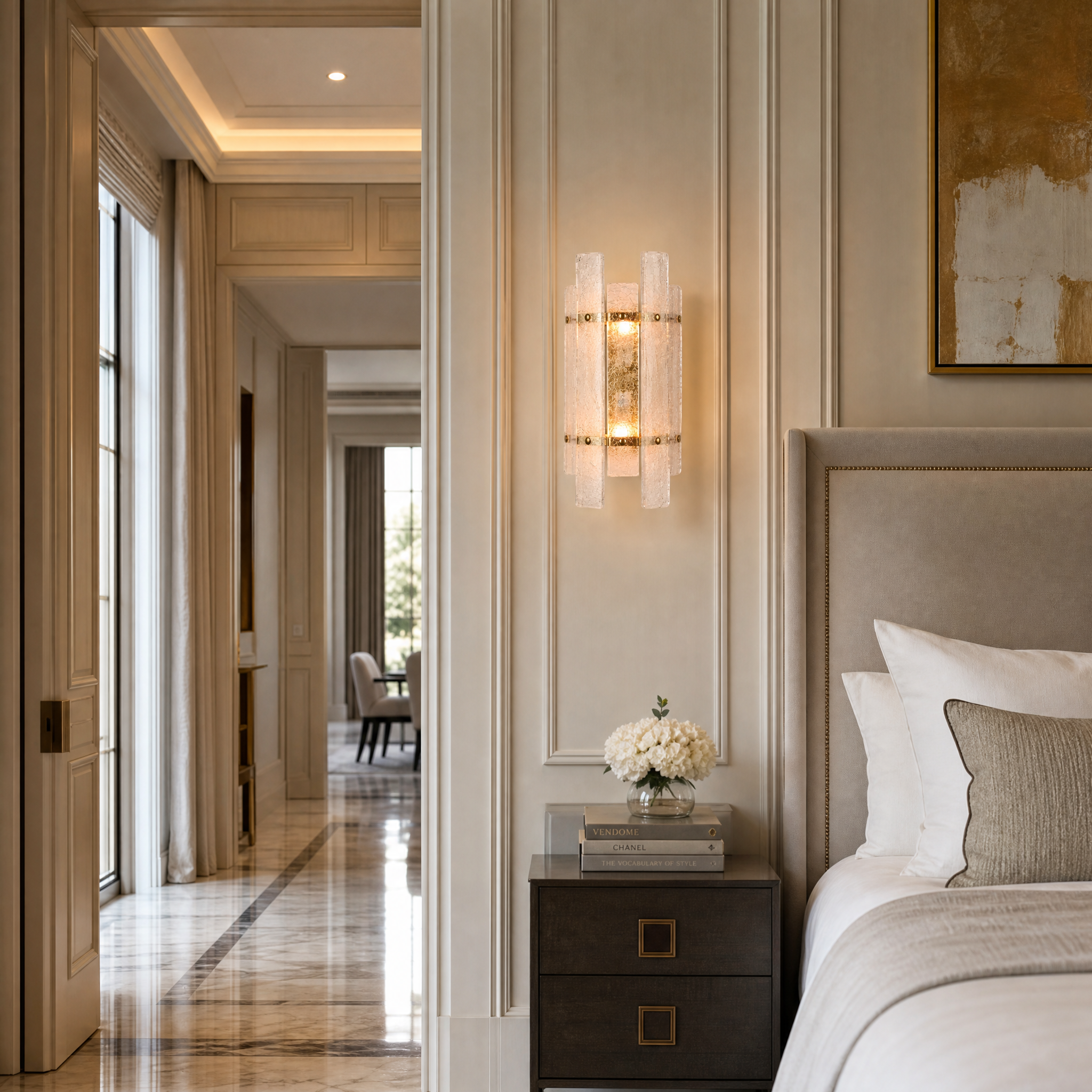 Tavolino Art Deco brass wall sconce installed in a luxury residential bathroom next to a vanity mirror.