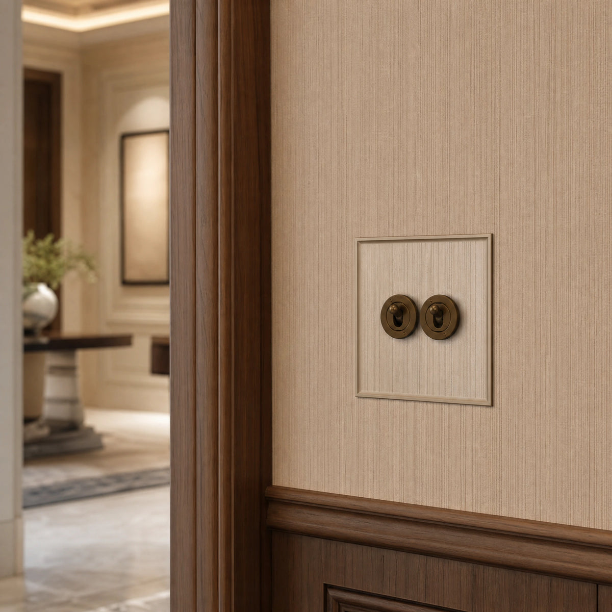 Close-up of a luxury bronze antique toggle switch installed within feature wall beside an elegant doorway with refined timber panelling by VORELLI®.