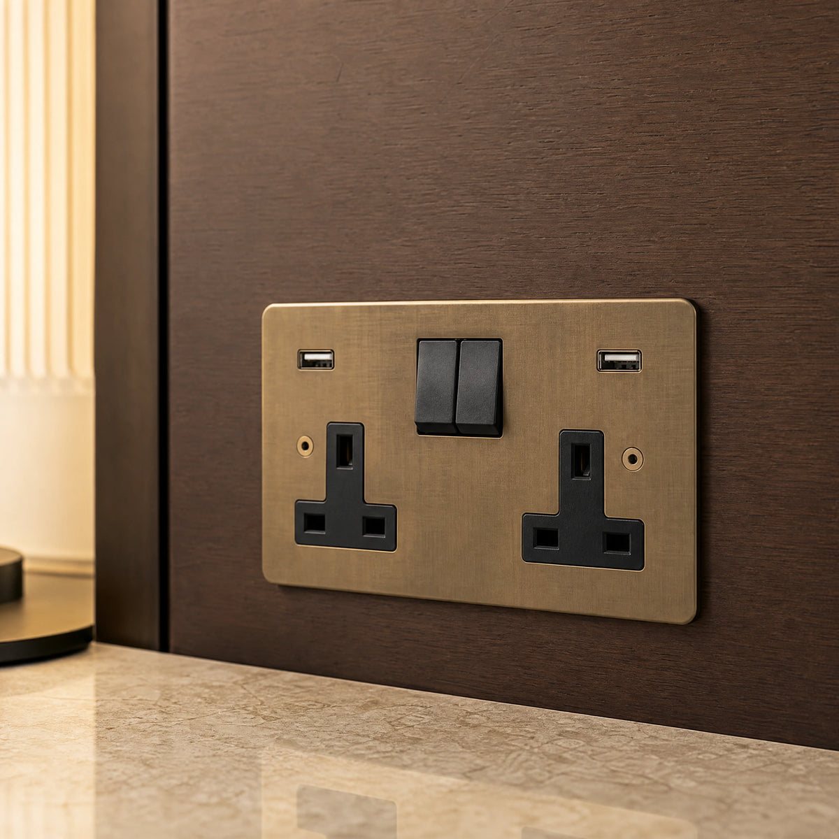 Close-up of a luxury antique brass usb socket installed within bespoke bedside joinery in a luxury bedroom suite by VORELLI®.