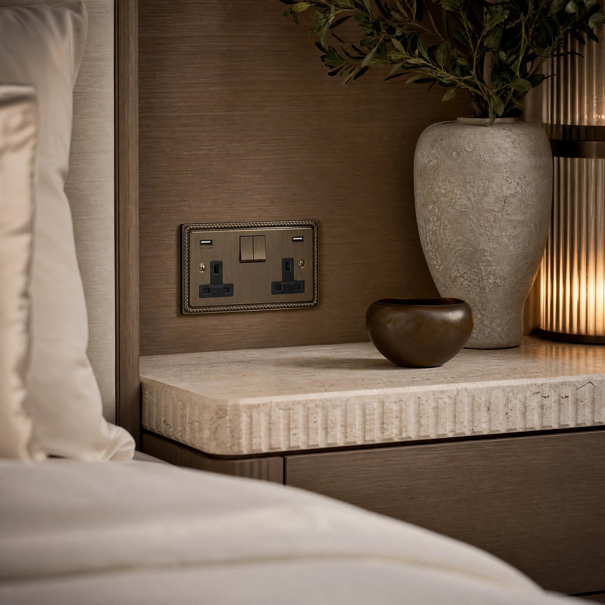 Luxury antique brass usb socket installed within bespoke bedside joinery in a luxury bedroom suite in a UHNW interior by VORELLI®.
