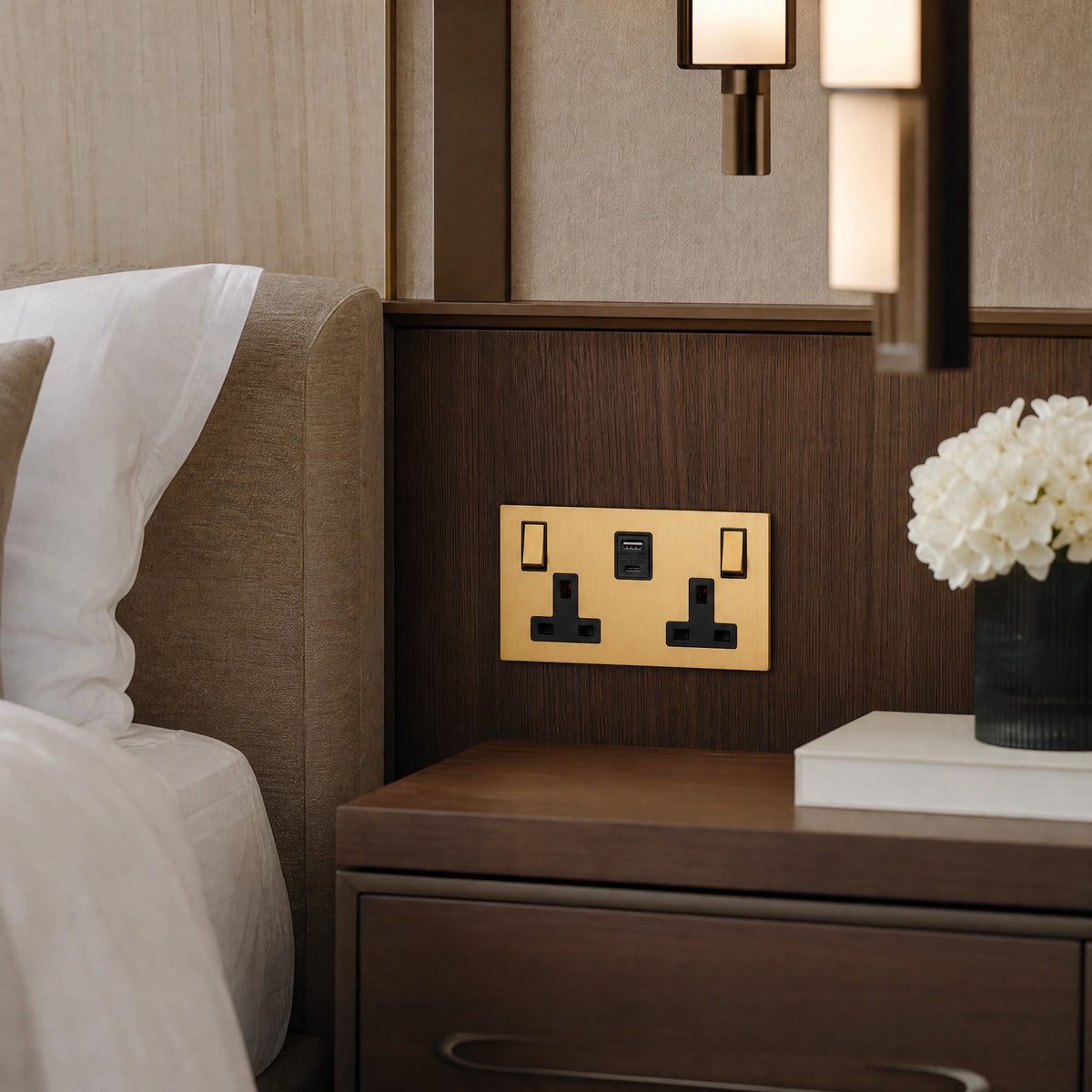 Close-up of a luxury ochre usb socket installed within bespoke bedside joinery in a luxury bedroom suite by VORELLI®.