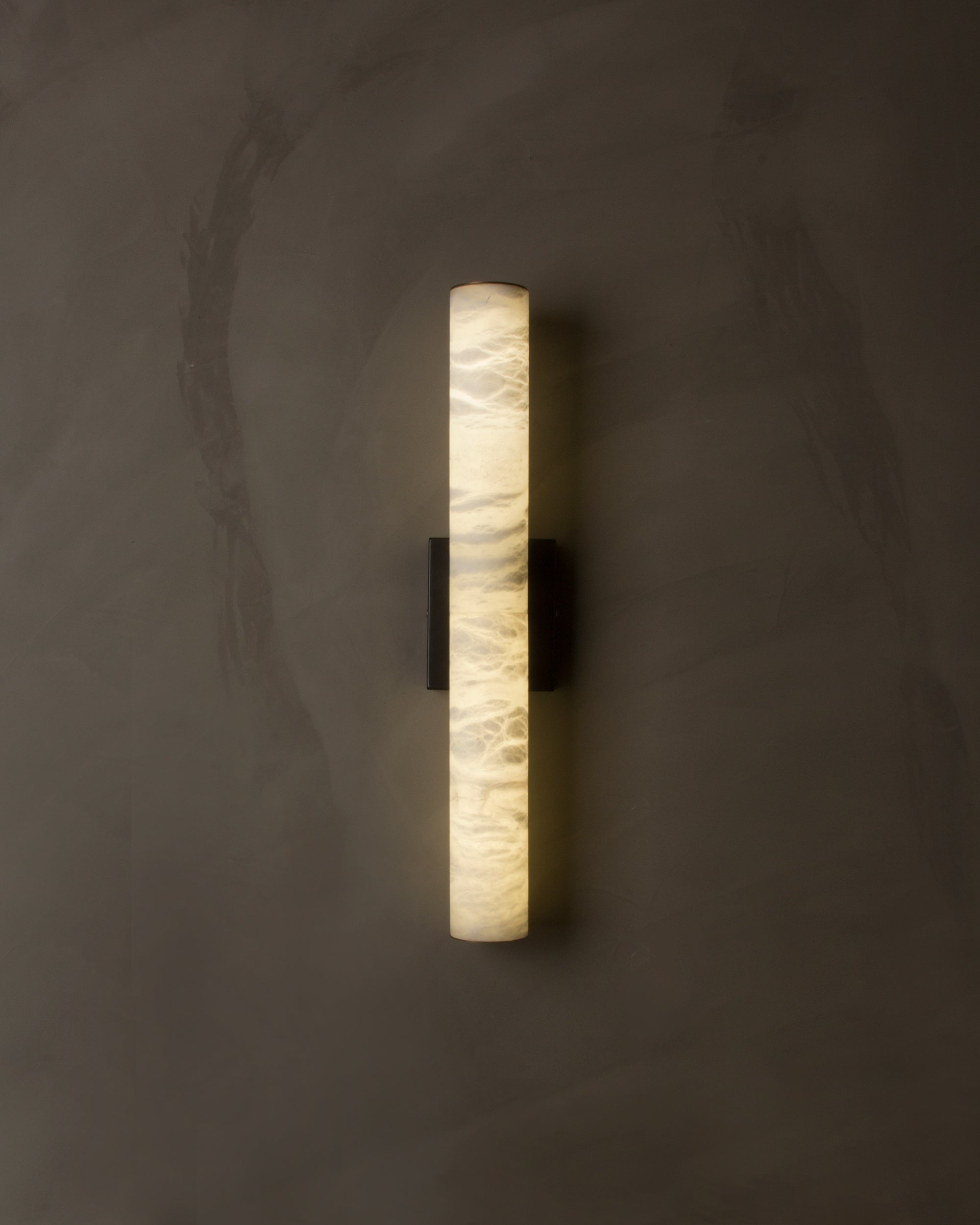 VORELLI® Velato alabaster wall light with warm ambient glow in luxury interior setting