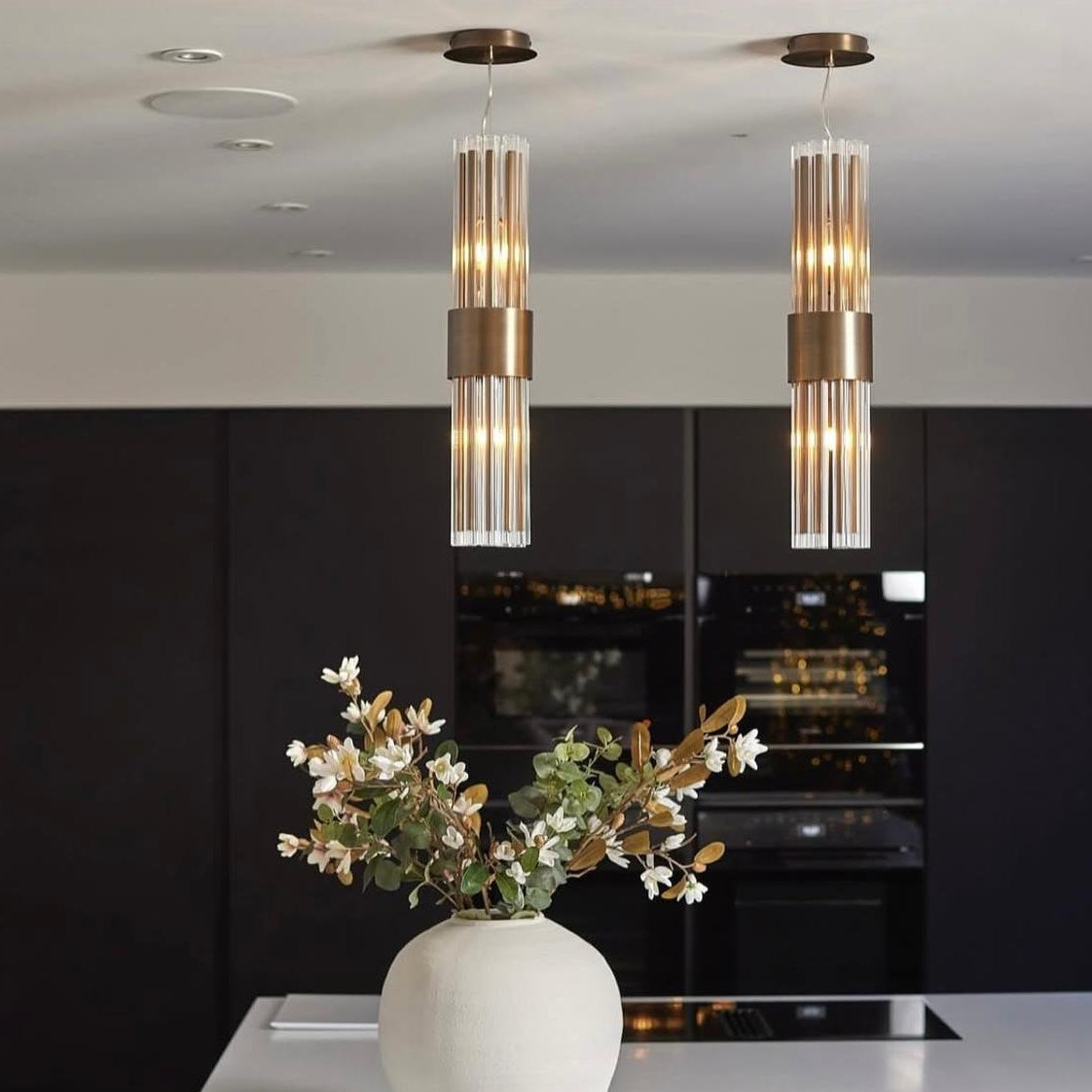 Luxury crystal pendant lights over kitchen island creating elegant ambient lighting