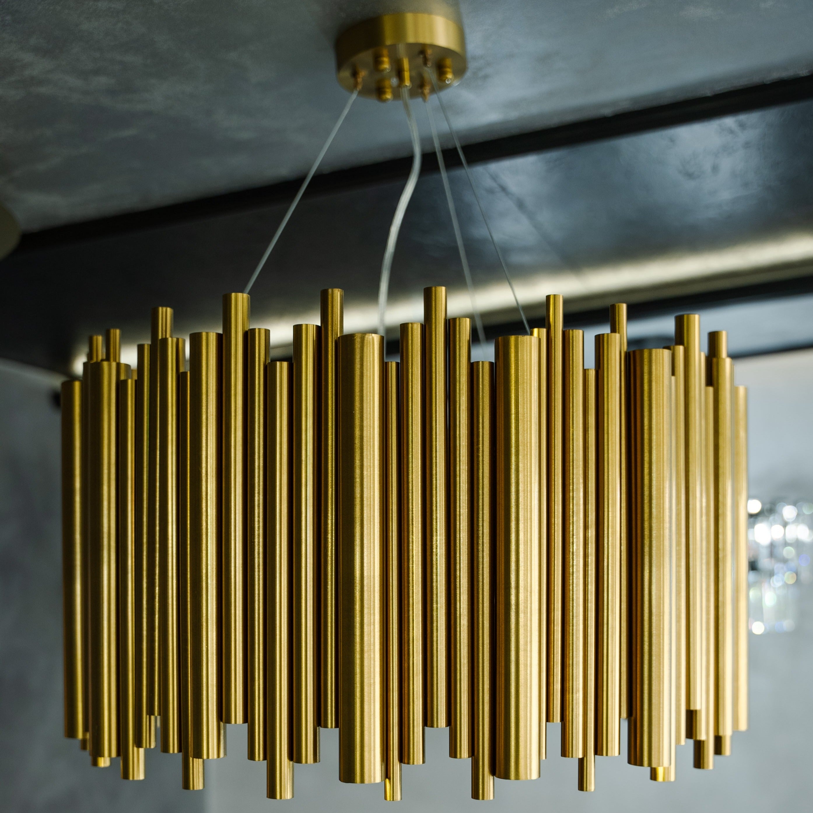 Close-up of cylindrical tube elements on circular chandelier showing refined modern design
