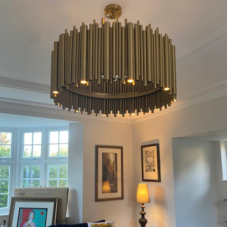 Luxury circular chandelier with vertical tube design in modern living room interior