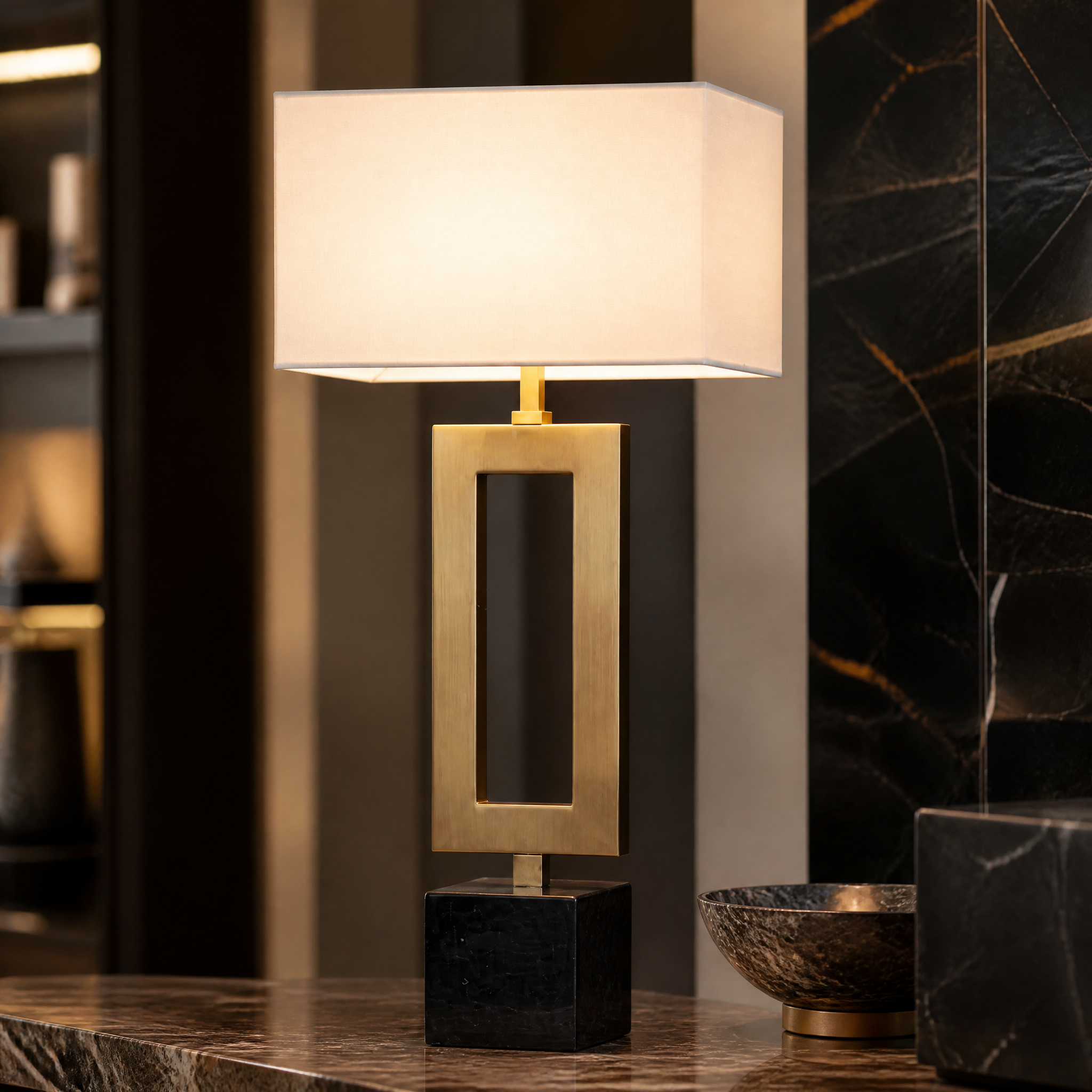 Close-up detail of the VORELLI Zavren table lamp showcasing the rich texture of the antique brass frame and the veining of the sleek black marble base.