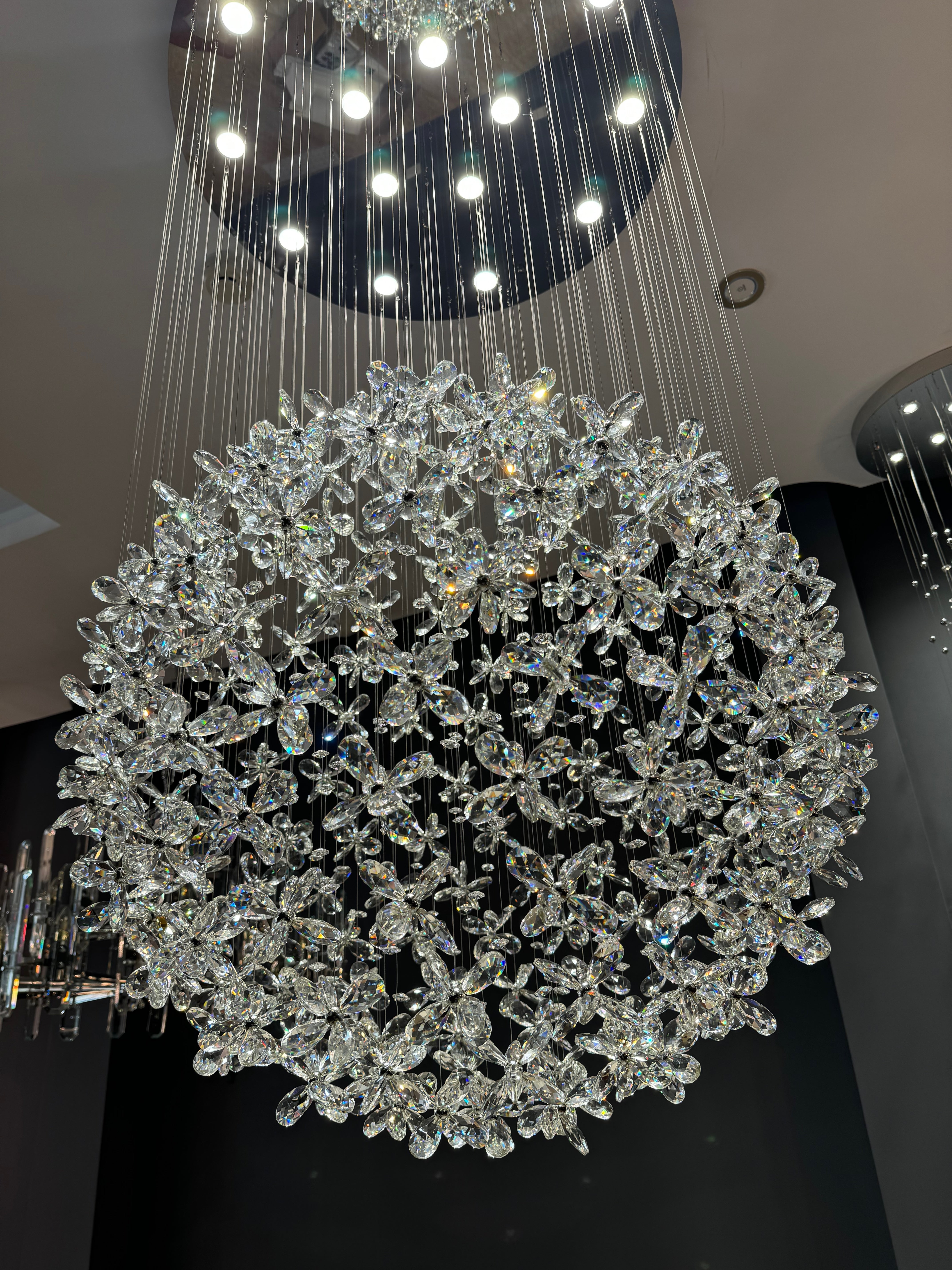 Side view of Whirlow staircase chandelier showing layered diamond cut flower crystal depth