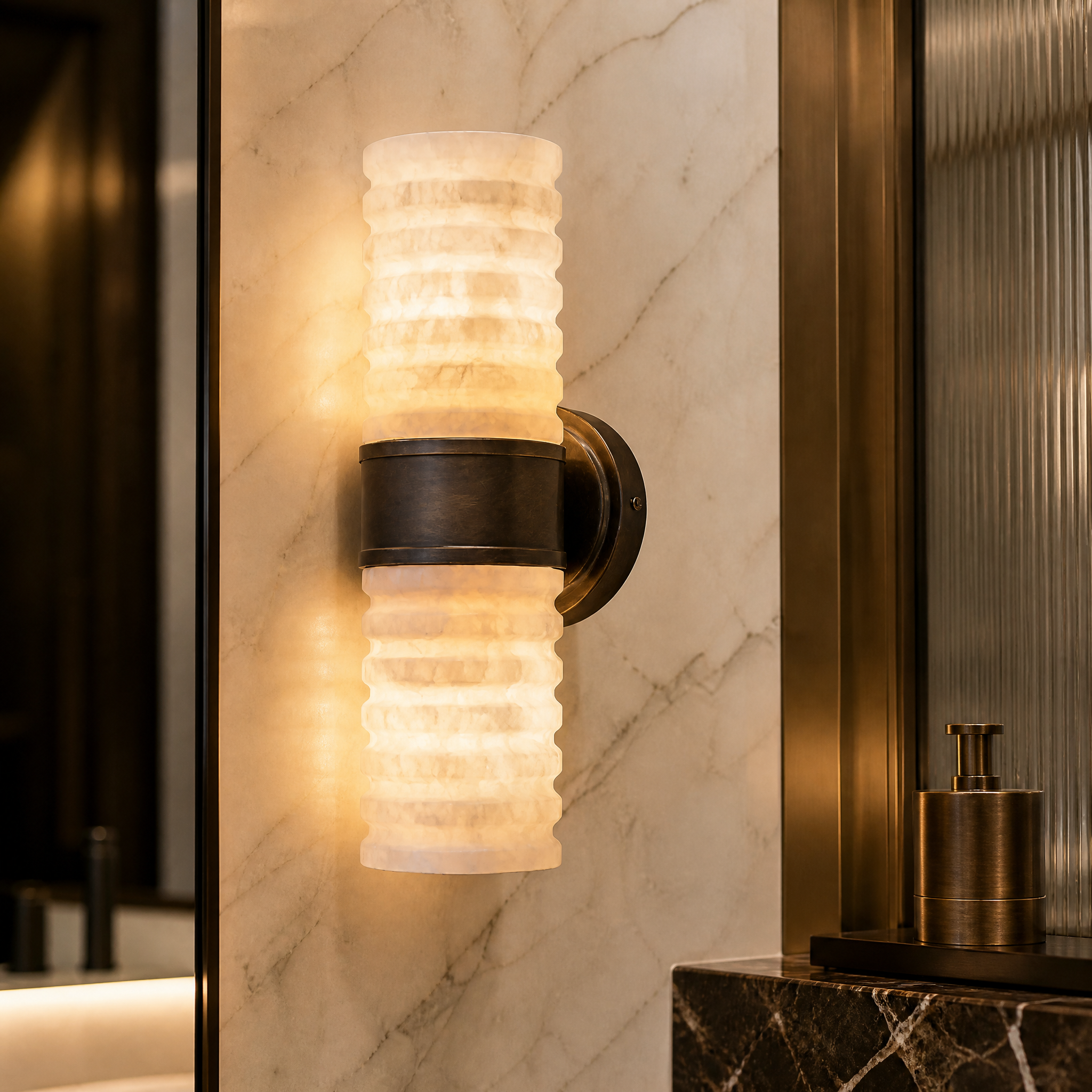 Close-up detail of the VORELLI Zavero wall light showcasing the natural veining of the dual ribbed alabaster columns and the architectural texture of the deep bronze frame.