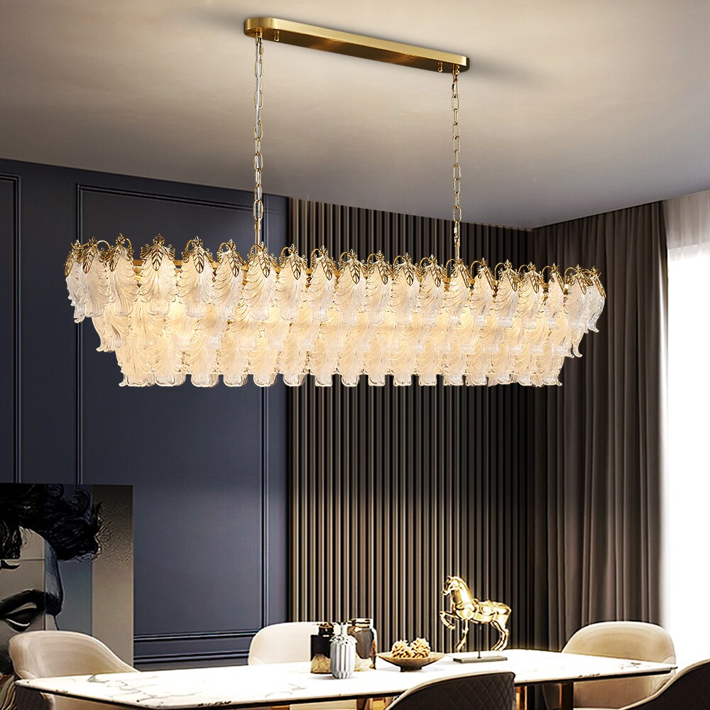 Julio Rectangular Chandelier suspended above a luxury dining table with cascading feather crystal detailing