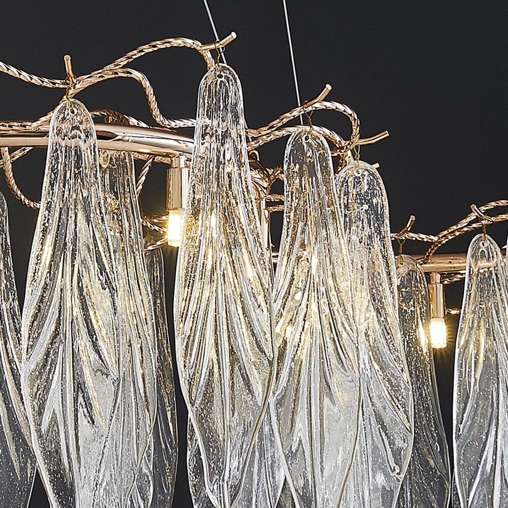 Close-up of Larvotto chandelier leaf-shaped glass suspended from sculptural branch frame