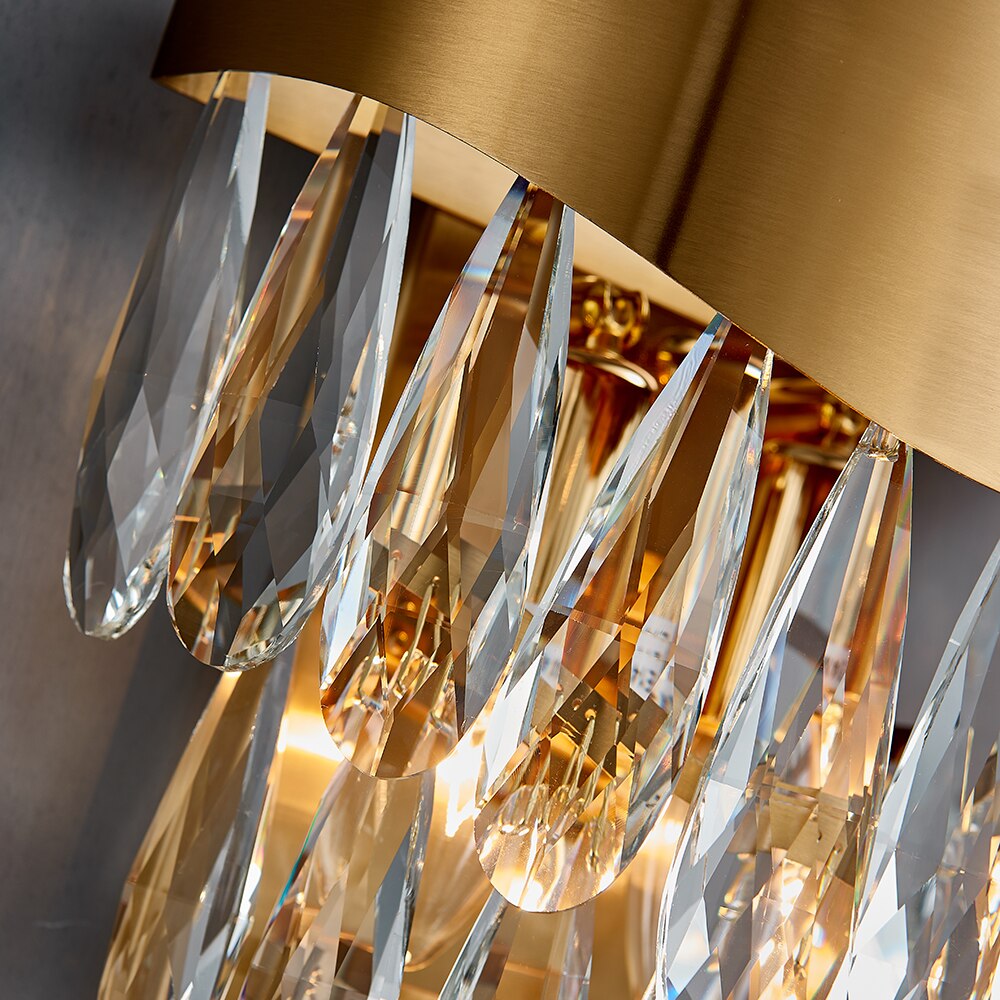 Close view of diamond cut teardrop crystals forming an elegant luxury wall light