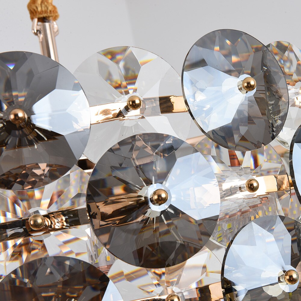 Decorative arrangement of diamond cut crystal discs on a luxury circular chandelier frame
