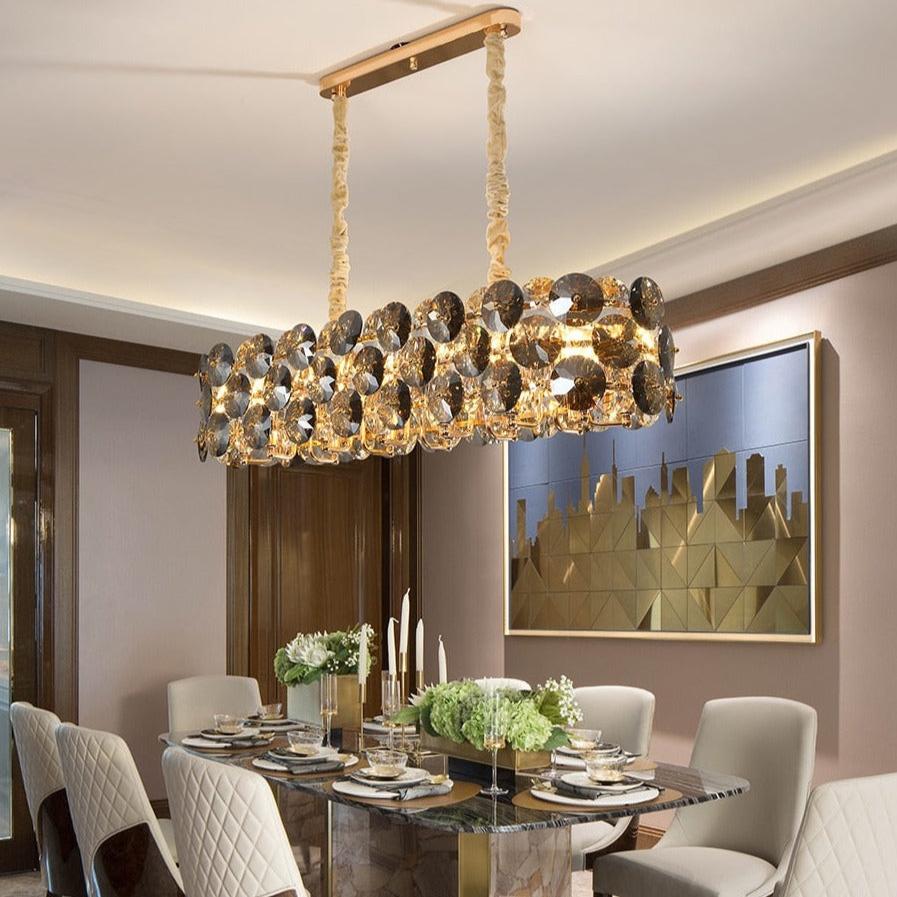 Modern dining interior illuminated by a luxury rectangular smoky crystal chandelier