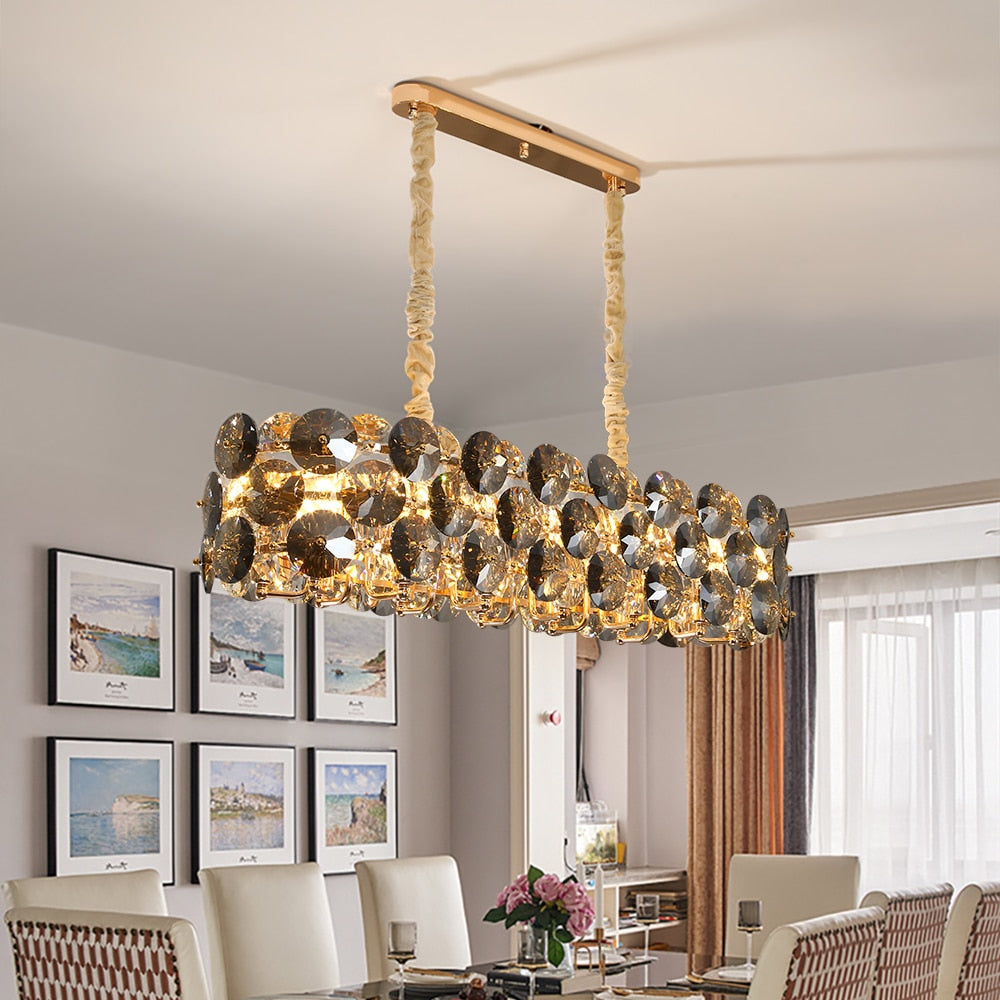 Lorenzo rectangular chandelier with clear and smoky grey diamond cut crystal discs above a luxury dining table