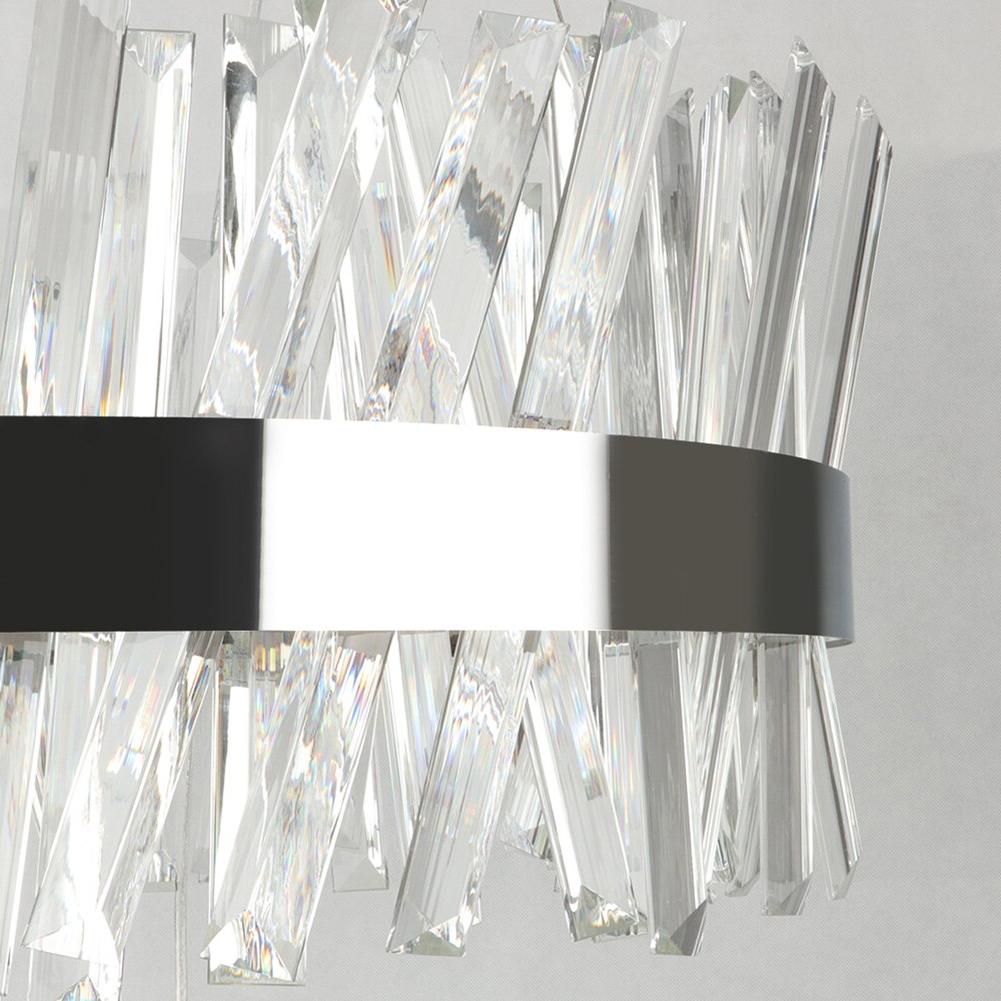 Detailed close-up of clear faceted crystal bars arranged around a circular chandelier frame