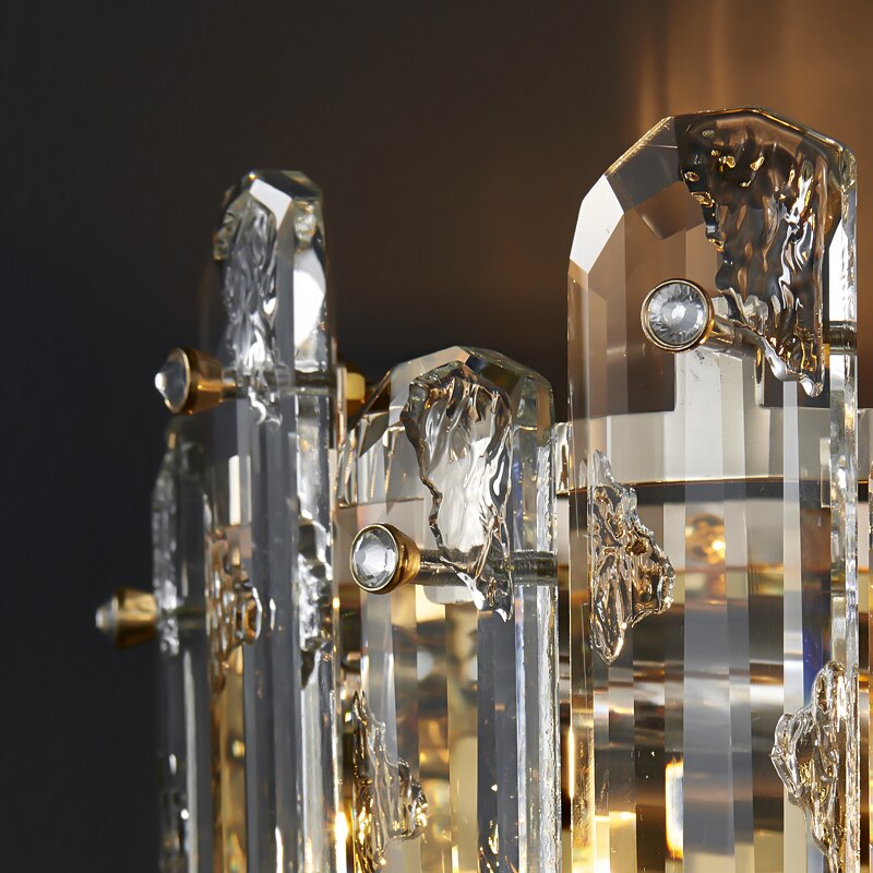 Close up of oblong textured crystal rods and polished metal frame on Stellina wall light