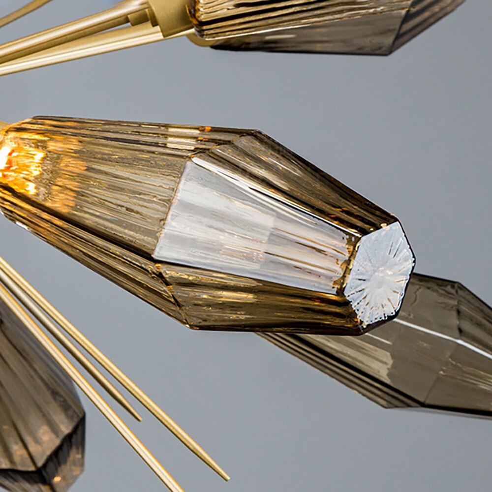 Close-up of VORELLI® Abdera Pendant’s gold sculptural arm and textured smoky grey glass