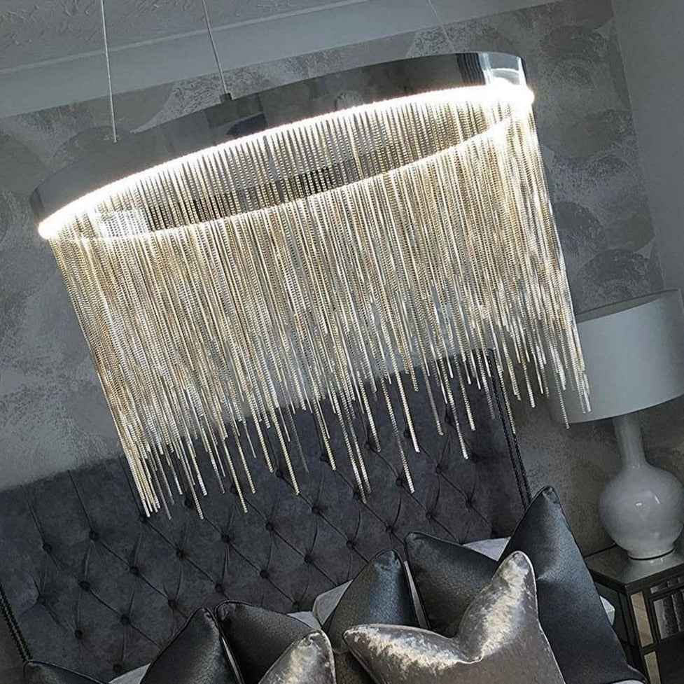 Side view of VORELLI® Adlington Circular Chandelier showing curved chain detail in a showroom