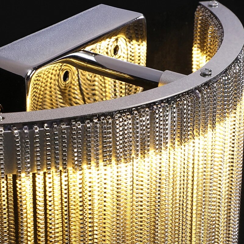 Detailed capture of the Adlington Wall Light in gold finish, highlighting the shimmer and luxury of the metallic chain fringe.