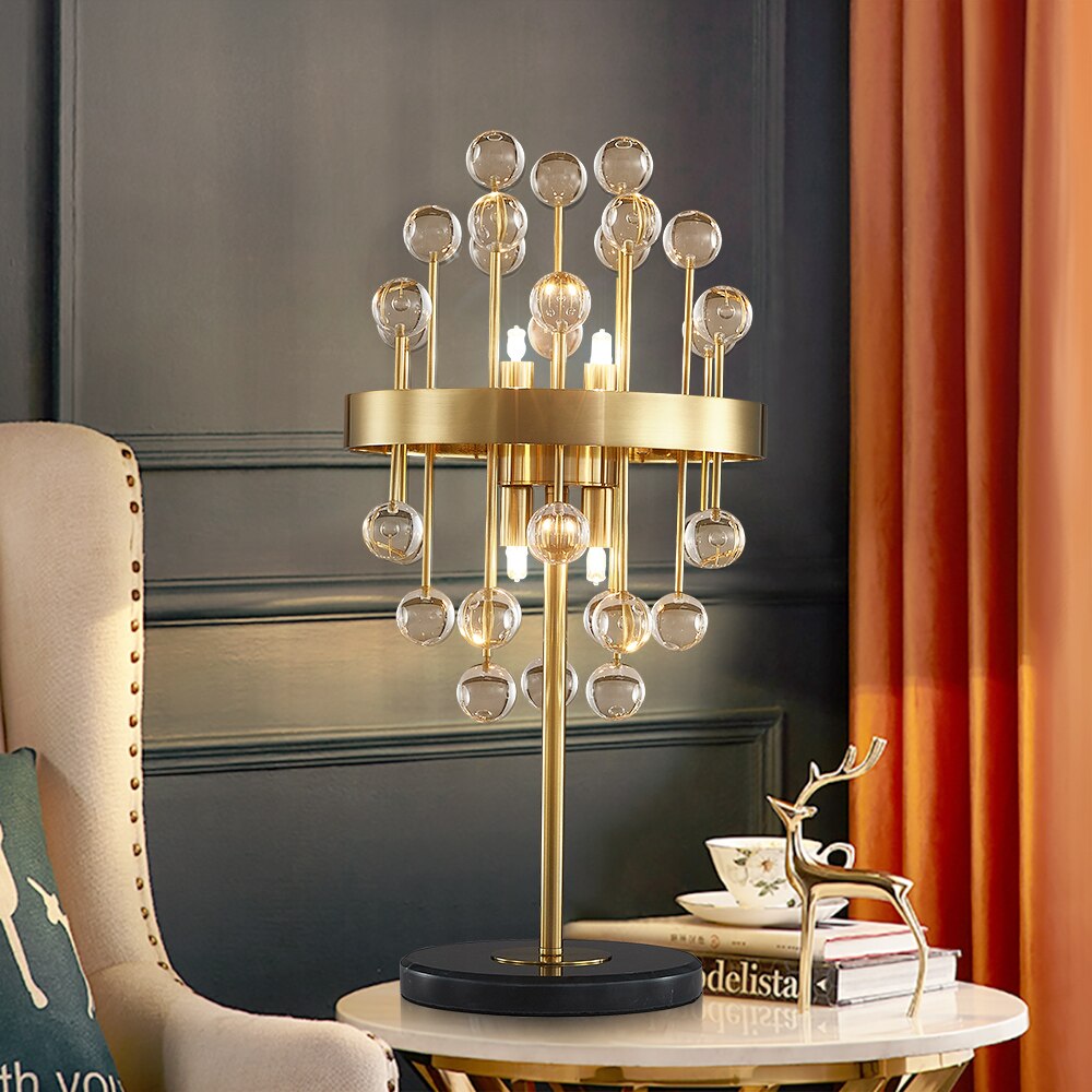 Side angle of the Alytus Table Lamp featuring clear glass spheres and a mirrored backdrop for added elegance.