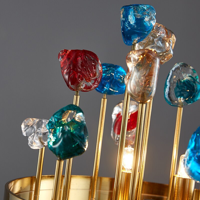 Artistic close-up of multicoloured glass spheres arranged on gold arms of the Alytus Table Lamp.