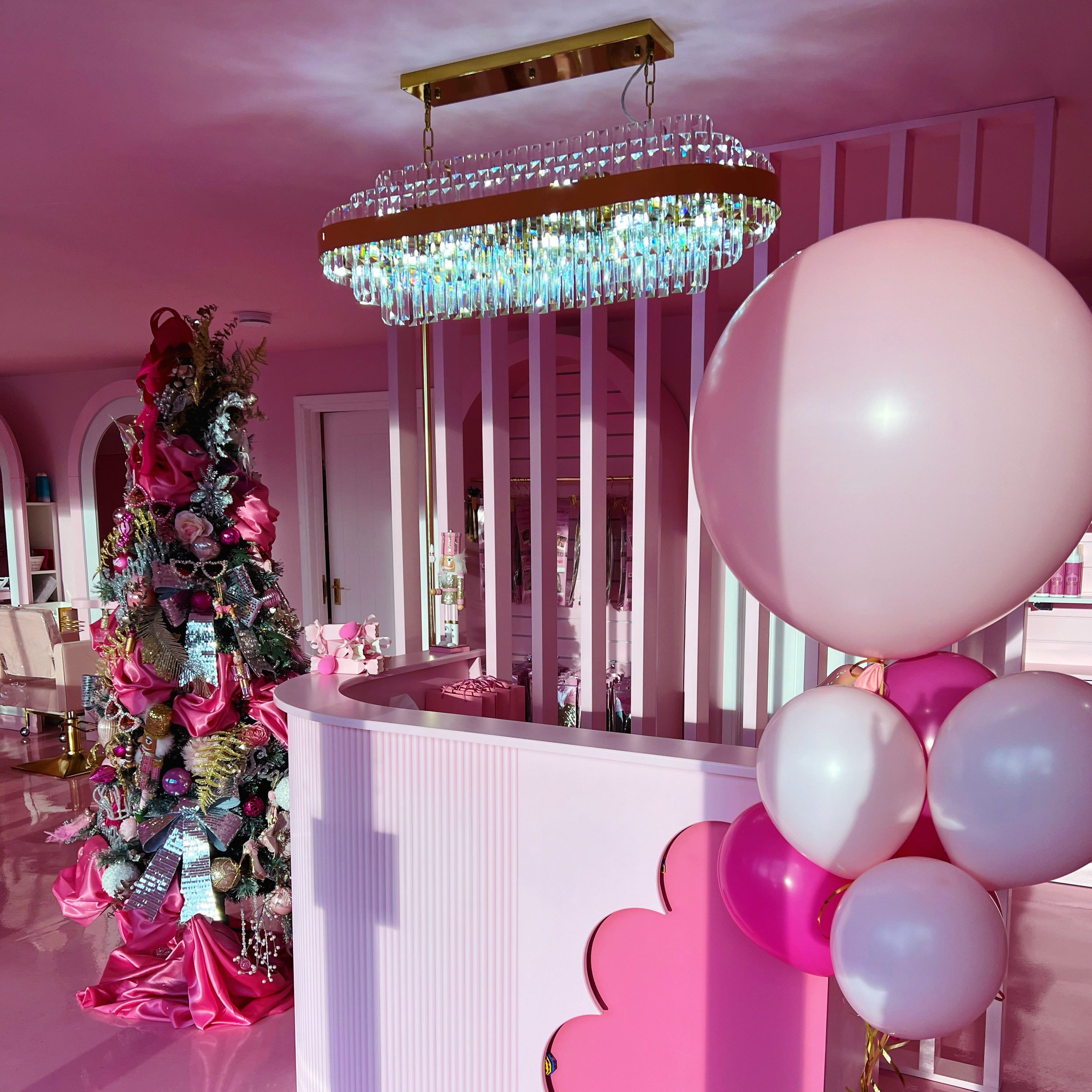 Rectangular crystal chandelier installed in a decorative event setting.
