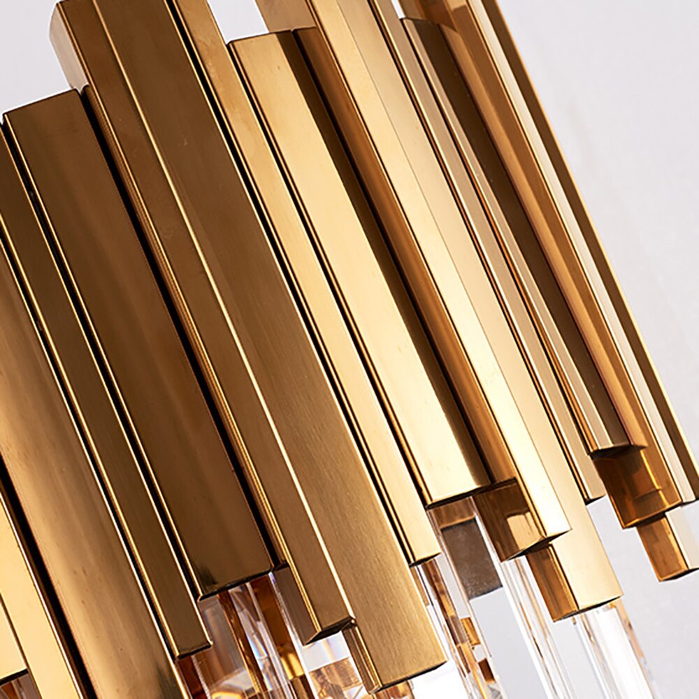 Close-up of sleek gold cuboid tubing on the Boeotia Double Wall Light.