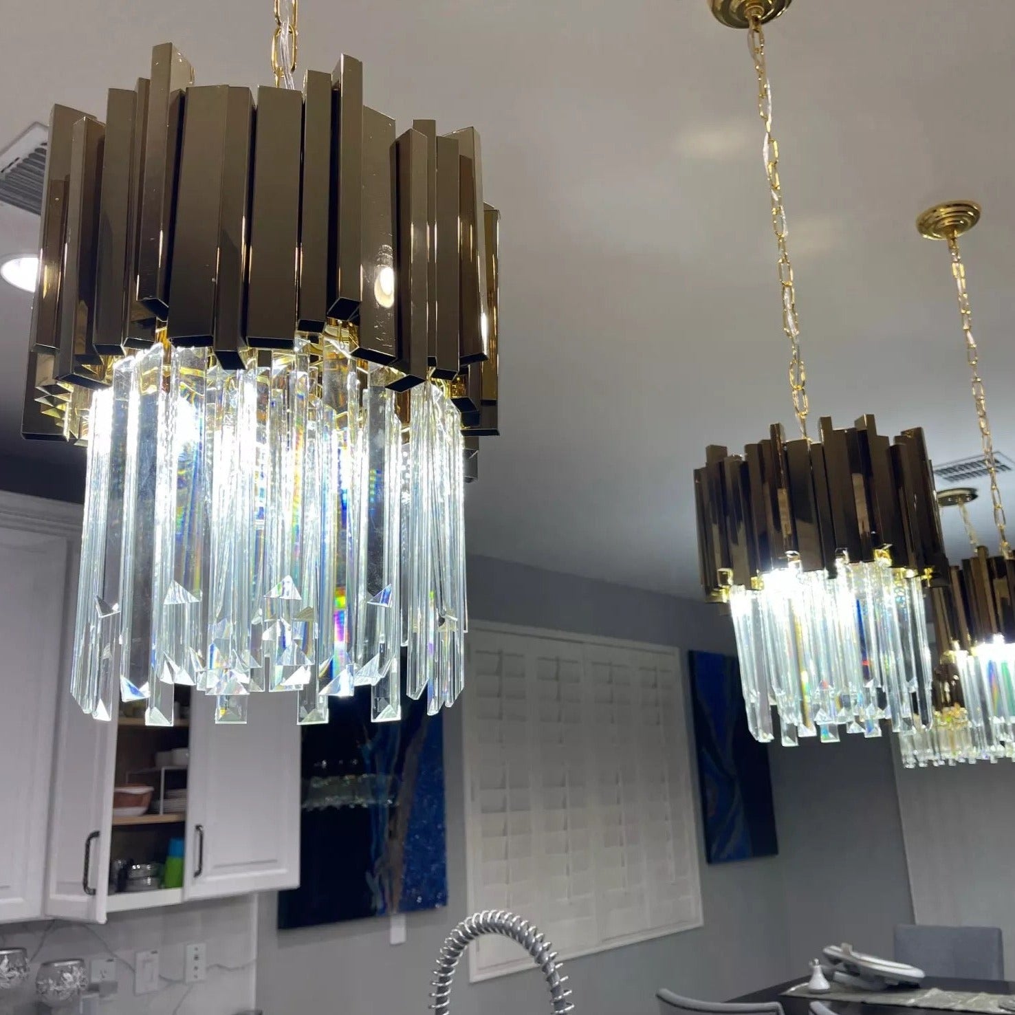 Close-up of the Boeotia Pendant showcasing gold cuboid tubing and crystal bar detailing.