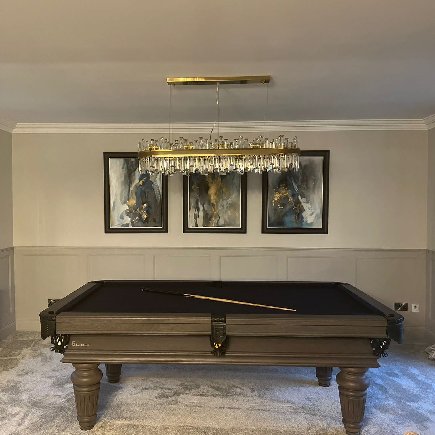 Brighouse Rectangular Chandelier suspended above a modern pool table with a warm ambient glow.